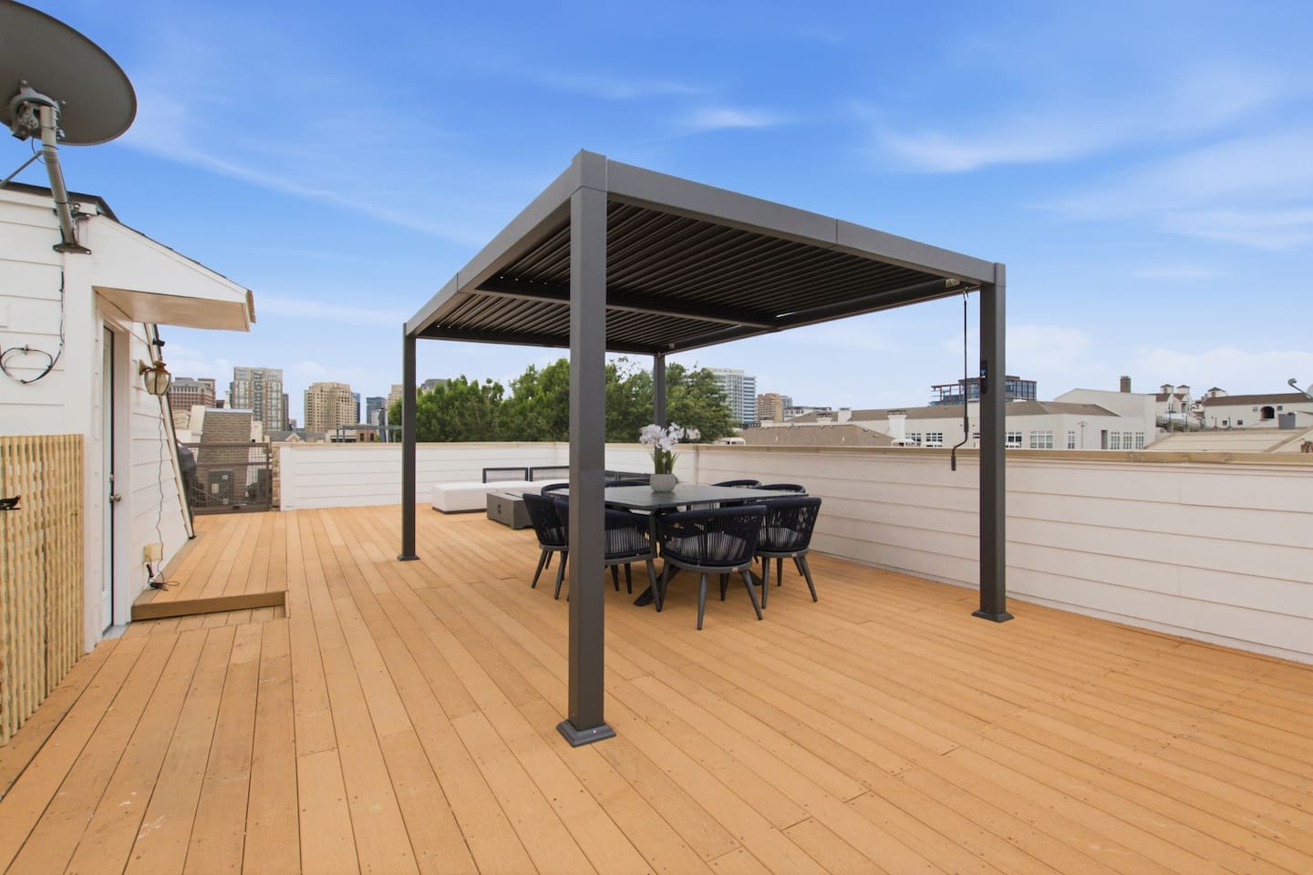 Rooftop deck with pergola, dining table, and unobstructed Dallas skyline views. One of the best private outdoor spaces in this part of the city, right above your front door.
