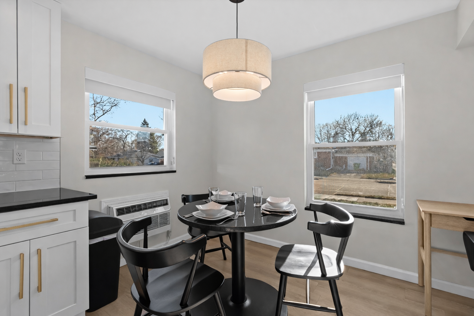 Bright dining area with modern seating, soft pendant lighting, and natural light—perfect for enjoying meals or gathering comfortably.