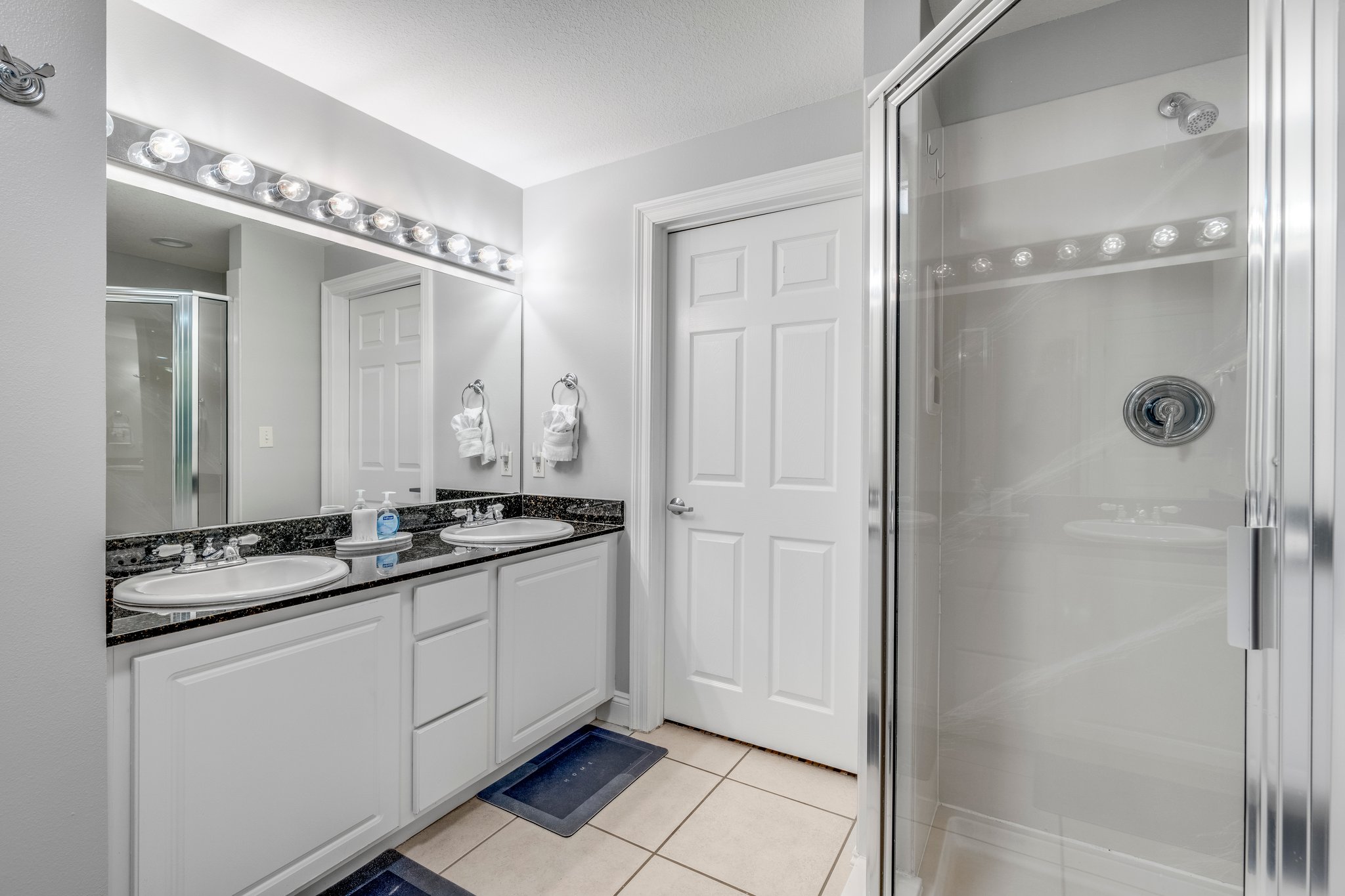 Large tub and walk-in shower with dual vanities