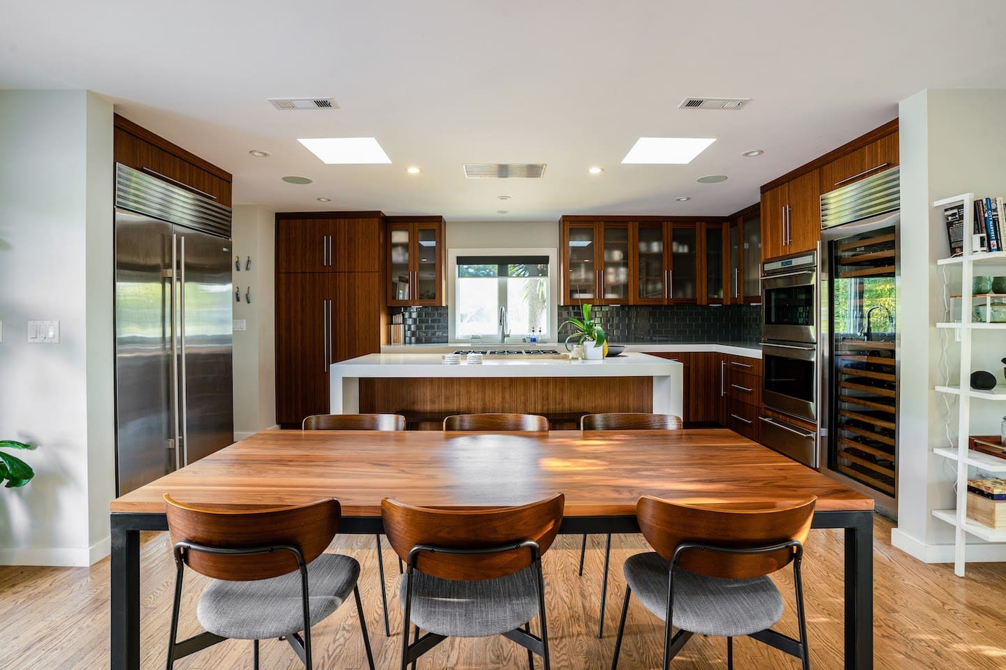 Fully stocked chef's kitchen with 8 person dining table and two person island seating.