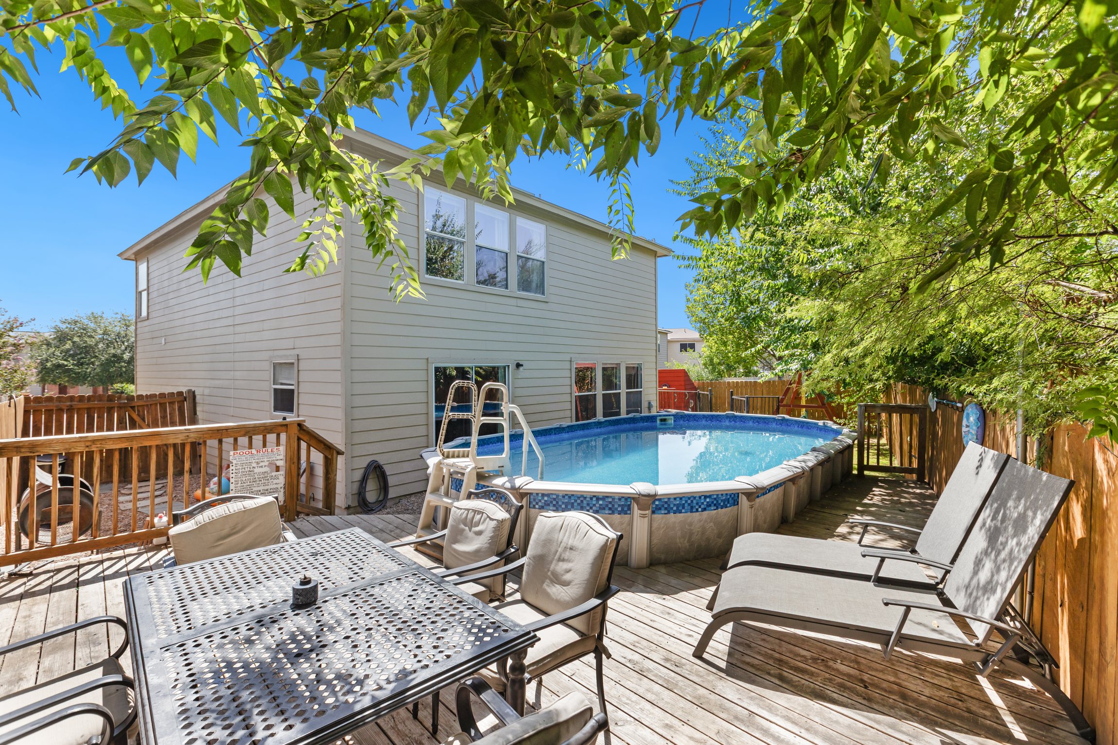 Private pool and lounge chairs in a fully fenced backyard — no shared pool, no crowds. Exclusive outdoor space for your group of up to 10 guests at this Northeast San Antonio vacation rental.