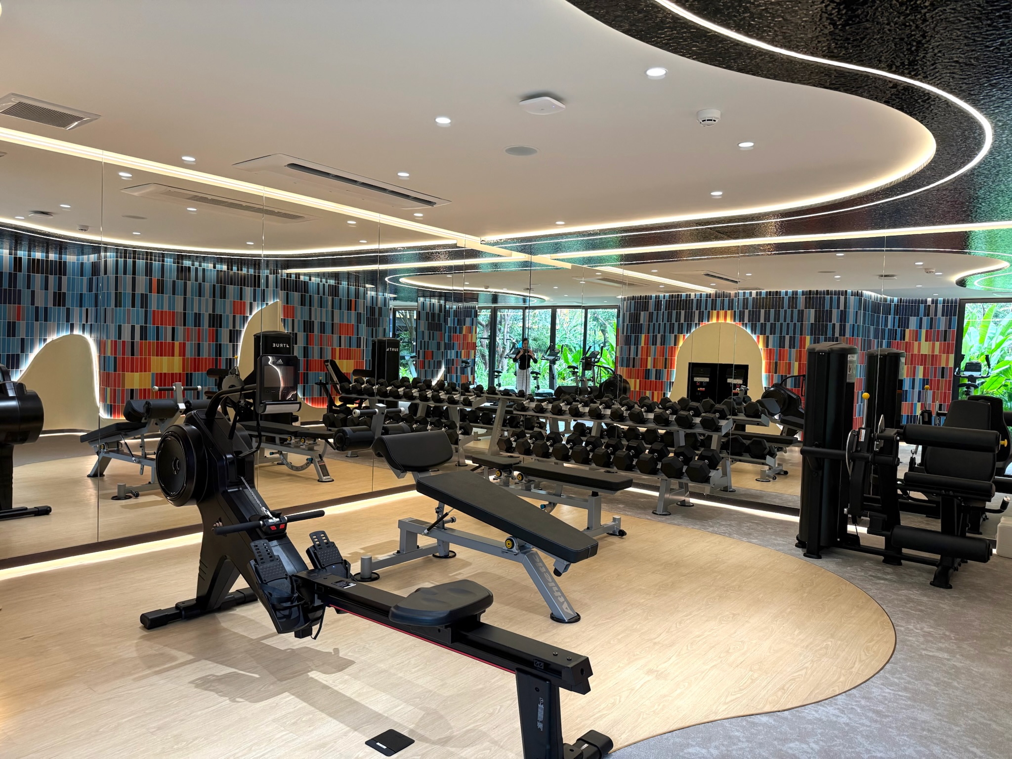 Enhance your workout—whether strength training or cardio—with an underwater-themed space featuring coral murals and garden views.