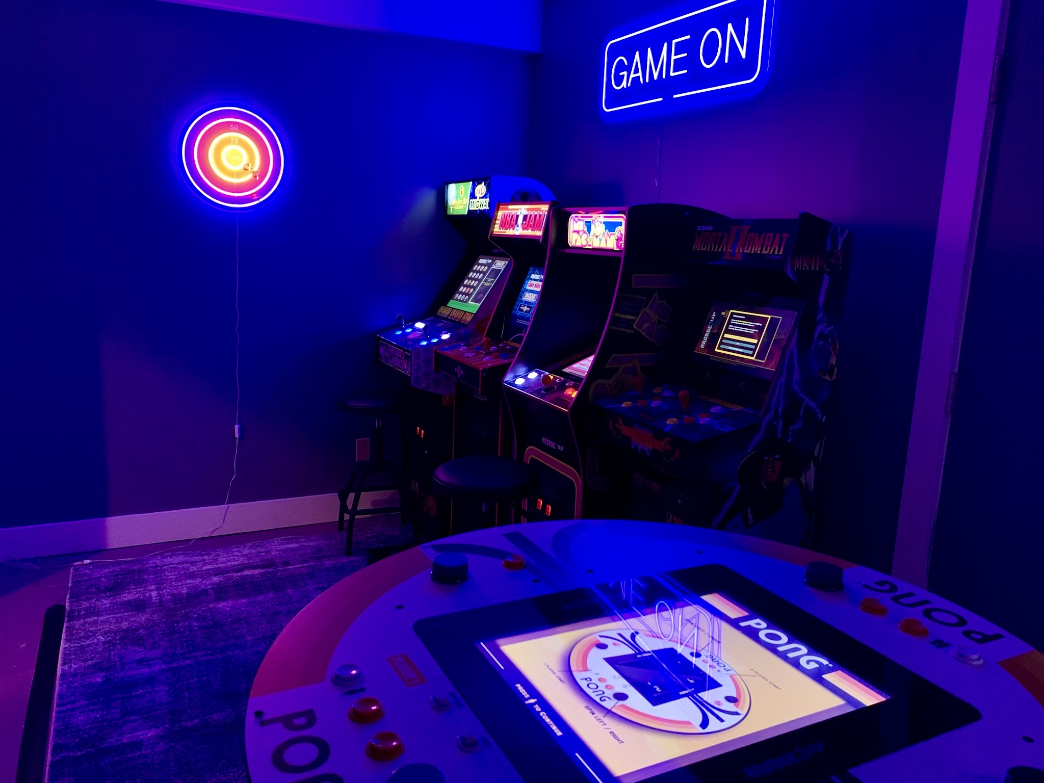 The dedicated arcade room is packed with nostalgic favorites—from Golden Tee and NBA Jam to Mortal Kombat, Ms. Pac-Man, and a one-of-a-kind 4-player Pong table.