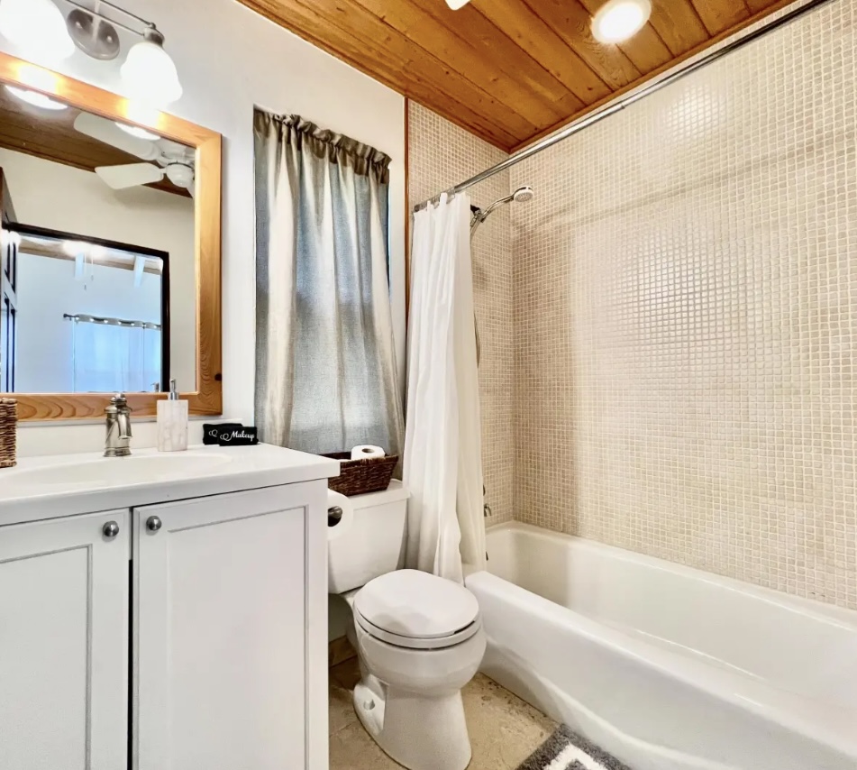 Full bathroom with shower/tub combo and built-in storage—ideal for groups and longer stays.