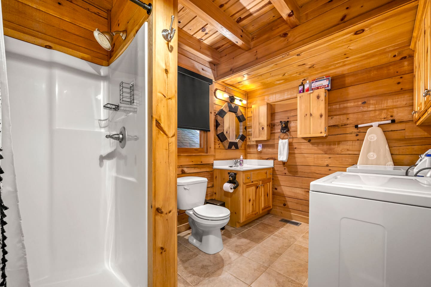 Second bathroom includes a walk-in shower, rustic wood finishes, and in-unit washer and dryer for added convenience during your stay