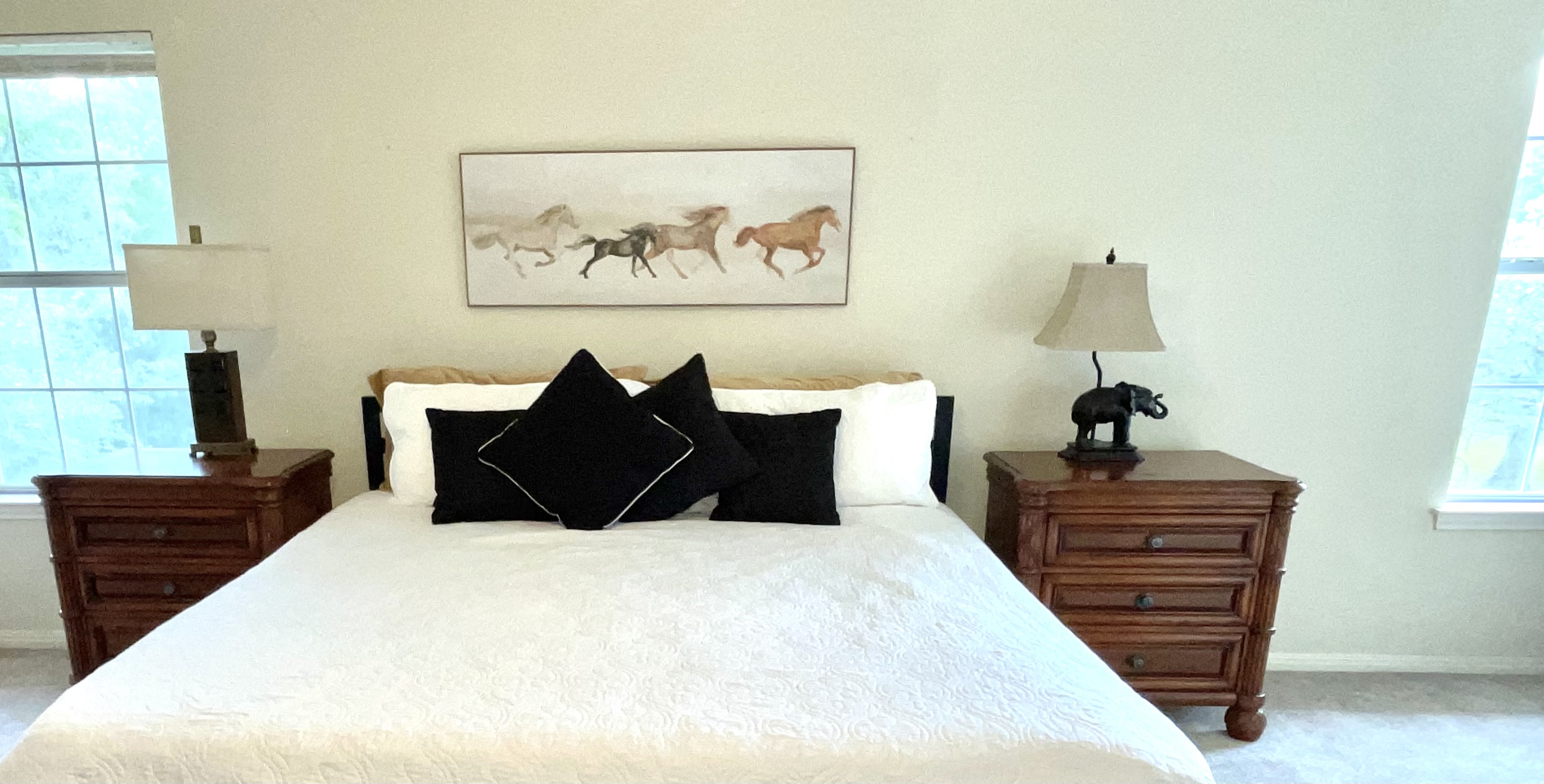 Spacious Master Suite Features King Sleeping, Memory Foam Mattress Topper, Bedside Charging Stations,  40-Inch LED Smart TV, and a Cozy Reading Nook/Office Space.