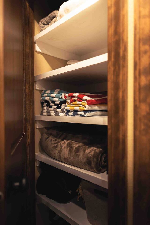 Linen closet with pool towels and extra blankets