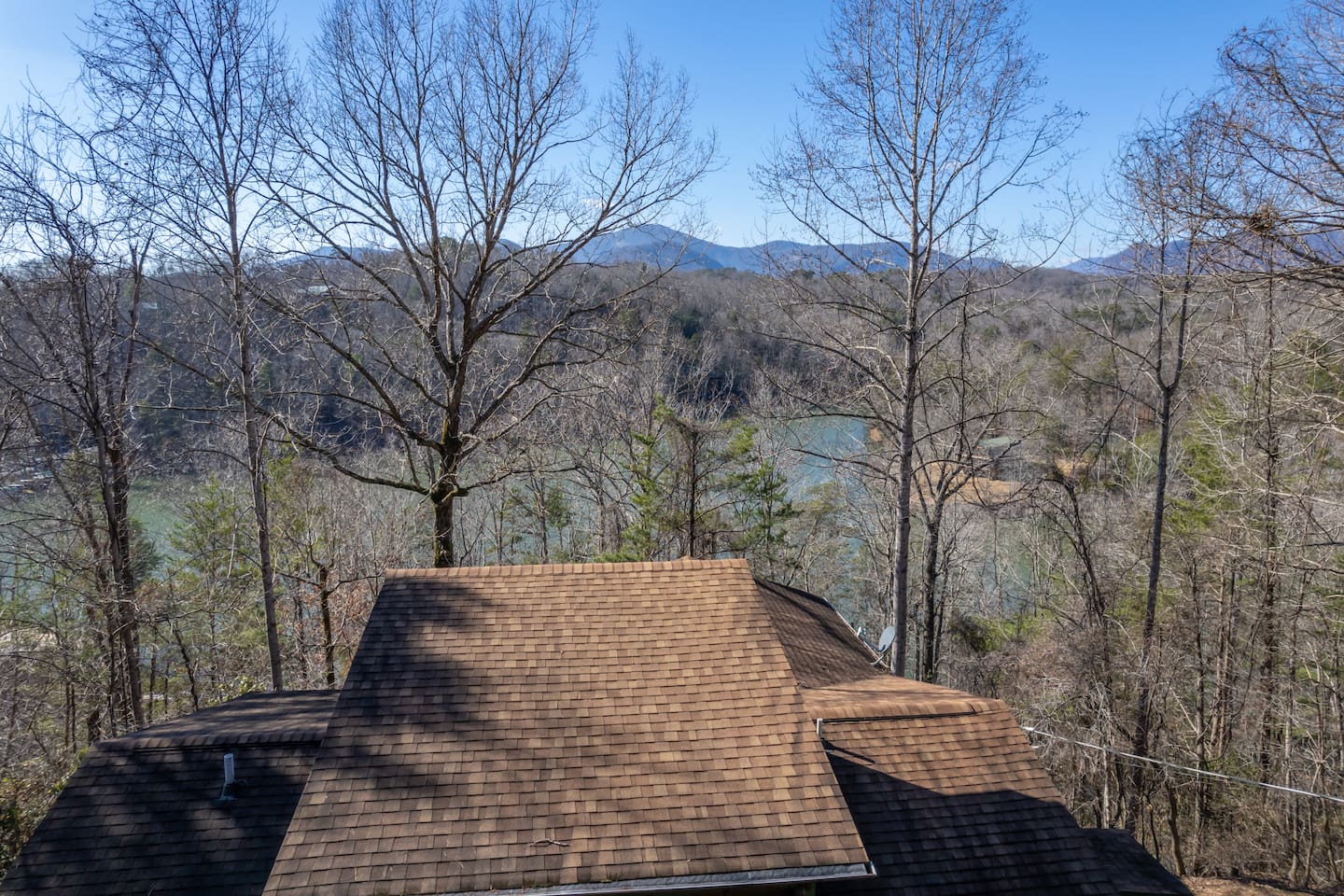 Upper drone view above the cabin. The cabin overlooks Mirror Lake in Riverbend at Lake Lure with mountain views