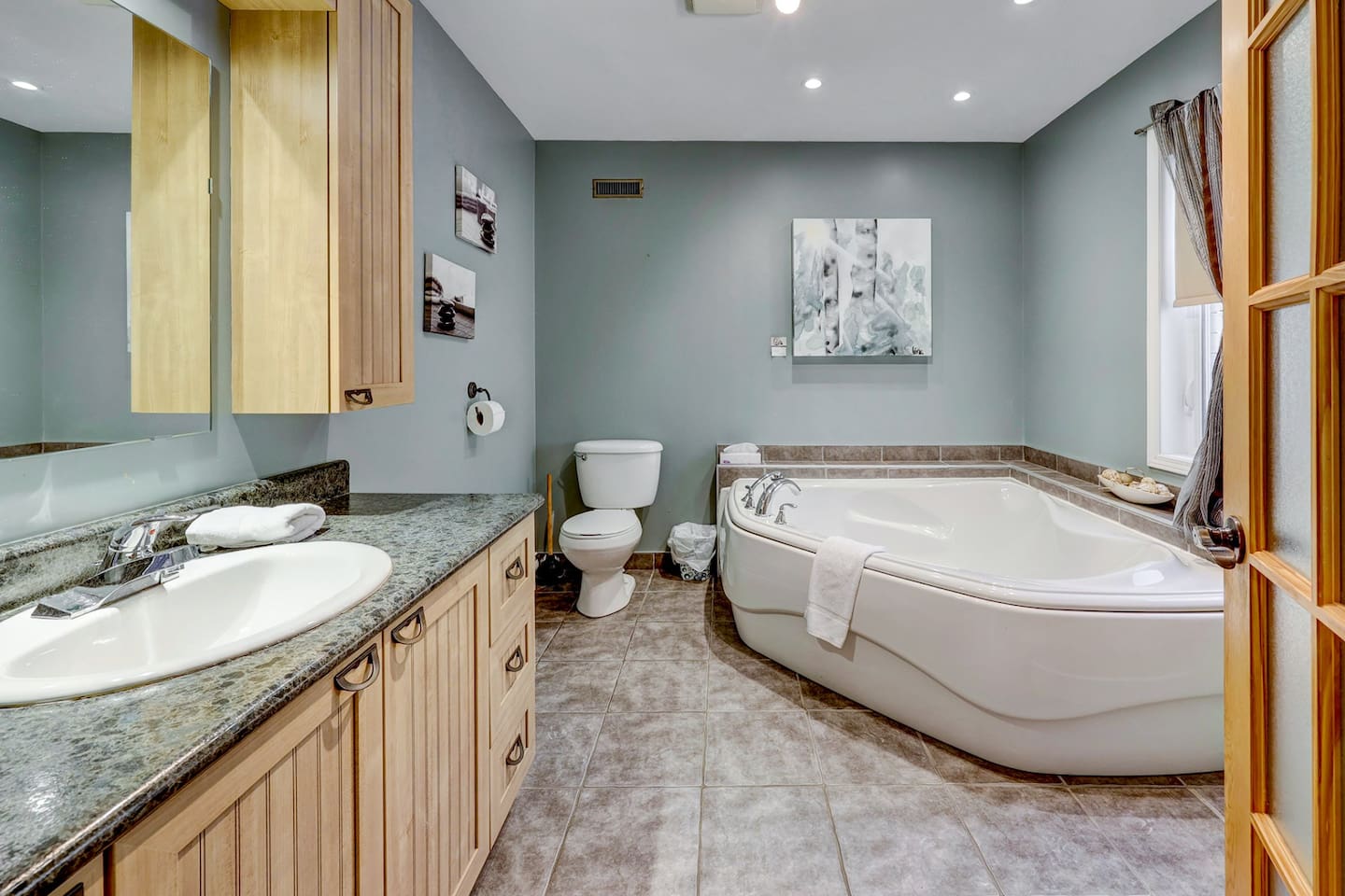 Enjoy modern comfort with a spacious vanity and tub.