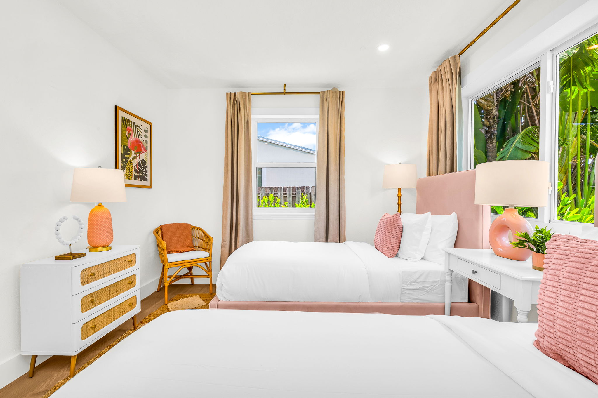 Chic and serene, this beautifully designed twin bedroom features plush velvet headboards, designer lighting, and abundant natural light with views of the lush tropical landscape—perfect for children or additional guests to unwind in refined comfort.