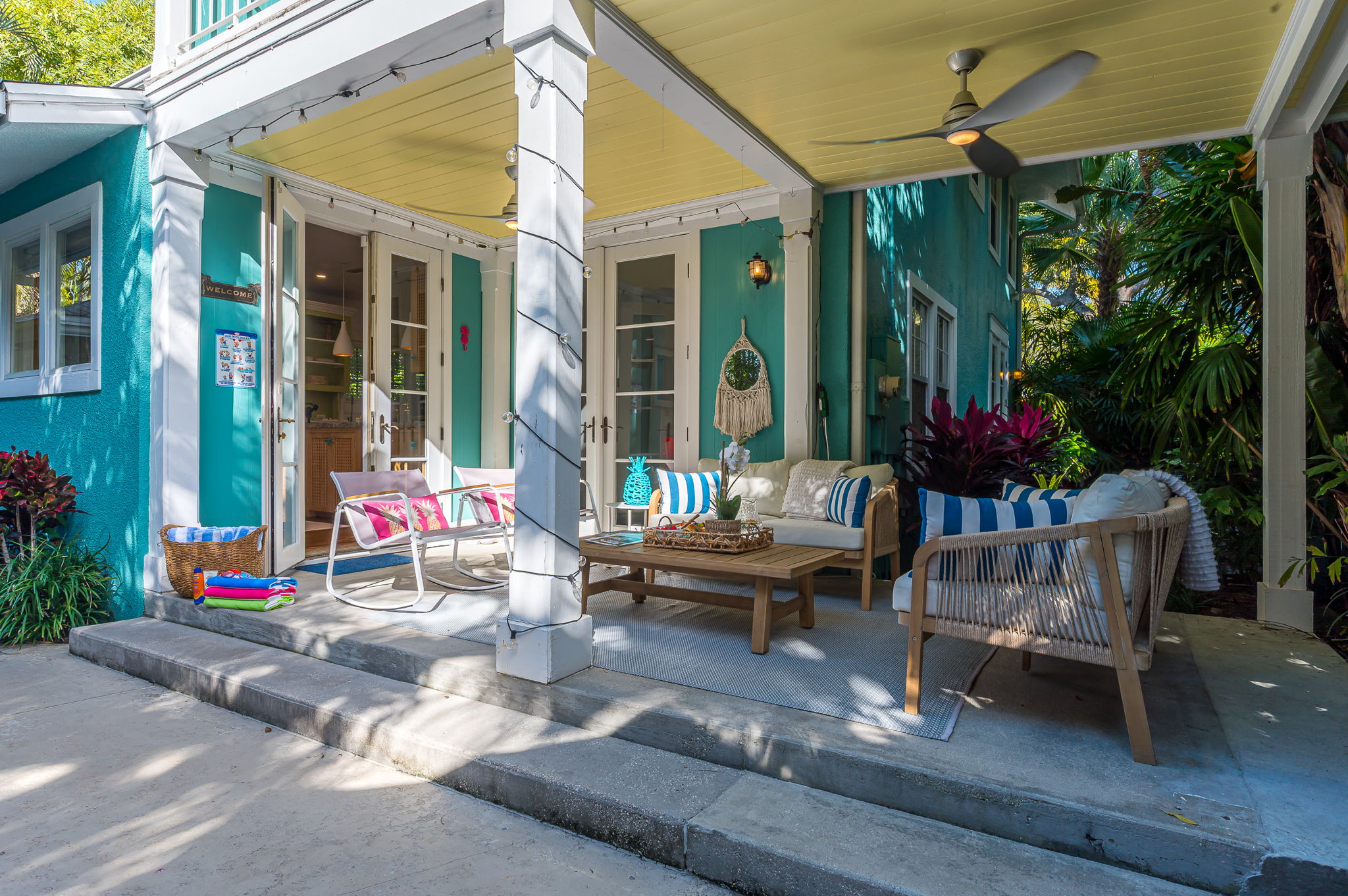 Step into your private tropical oasis featuring a heated pool, sun loungers, an outdoor shower, and a romantic string-lit cabana. Enjoy relaxing or entertaining under the covered patio with comfortable seating and dining, and magnificent pool views.