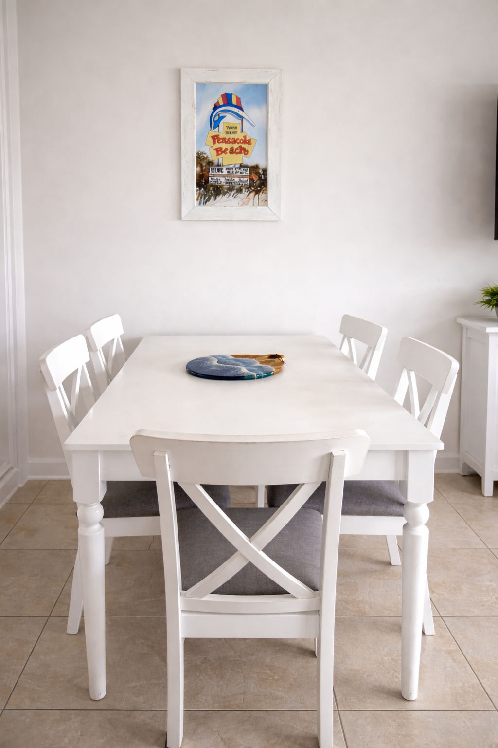 Bright coastal dining area with seating for six