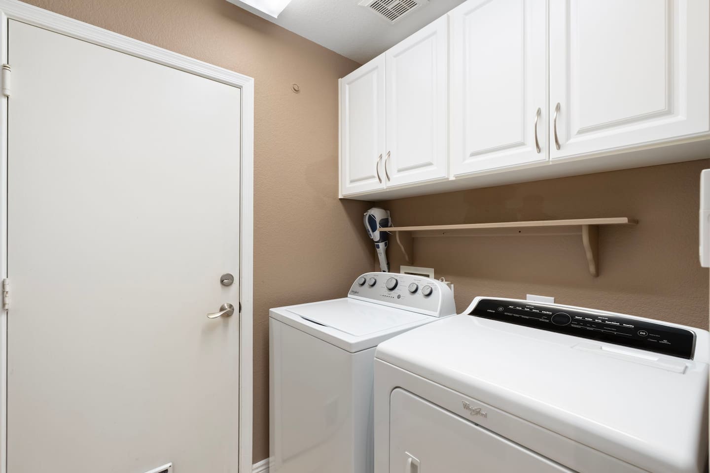 A full-size washer and dryer with overhead cabinet storage means you can pack lighter and leave fresher — no laundromat runs needed during your stay.