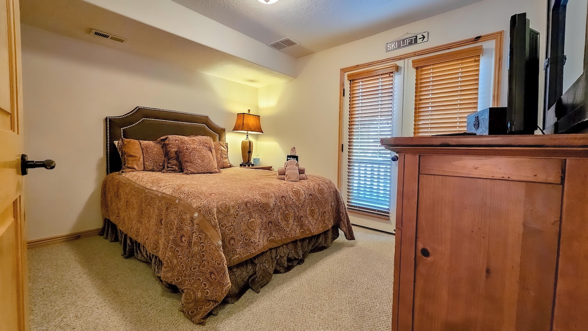 The second bedroom has a queen-sized bed, large screen TV and private deck access. 