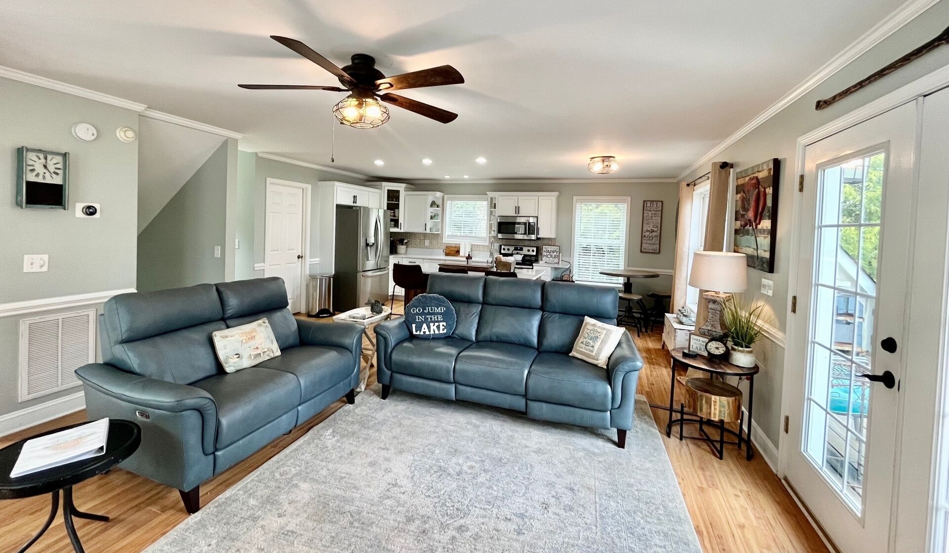 Living area with new sofas and remodeled kitchen