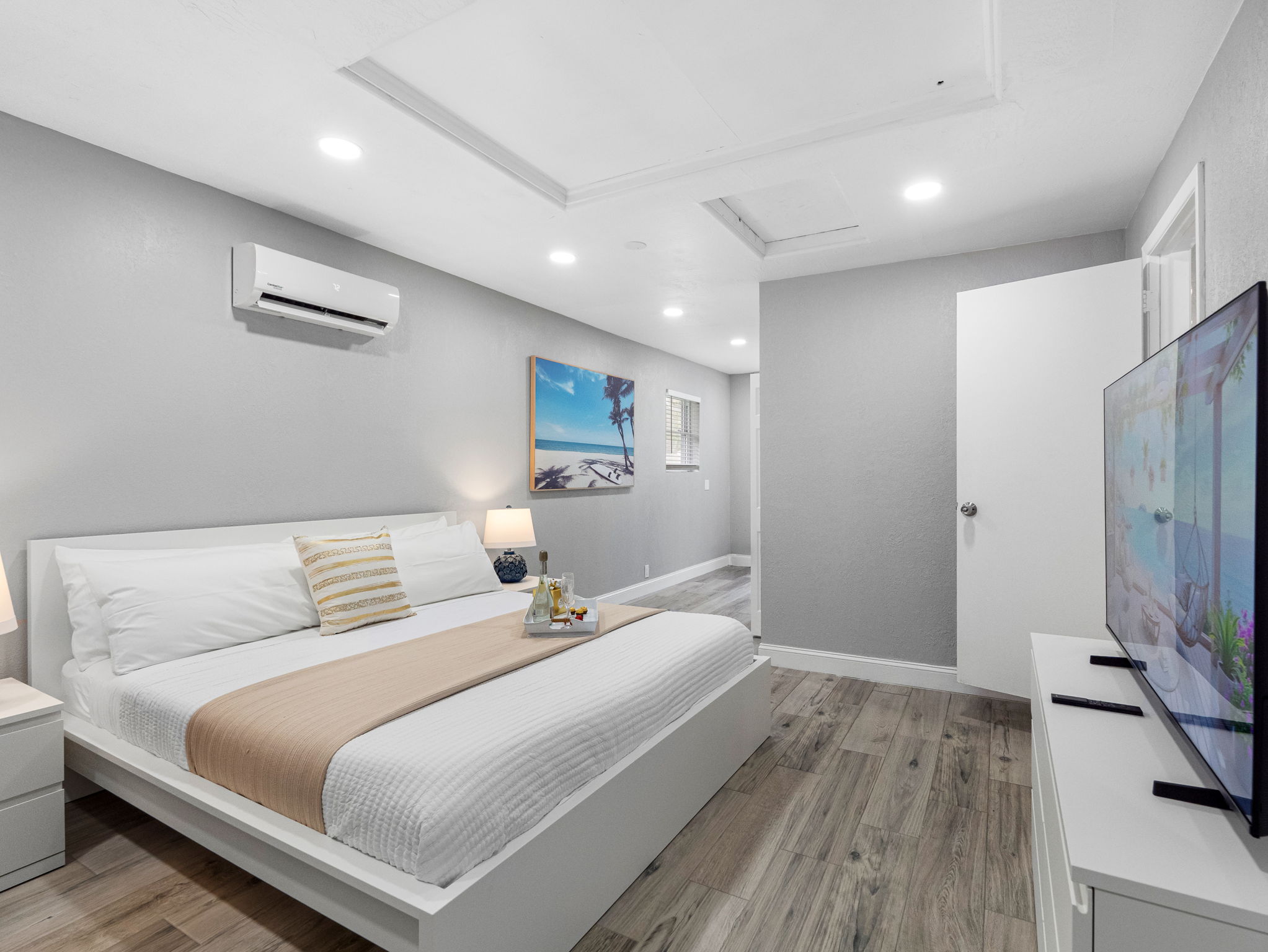 This peaceful bedroom is designed in soothing neutral tones, with sleek modern furnishings and soft ambient lighting for a truly relaxing stay.