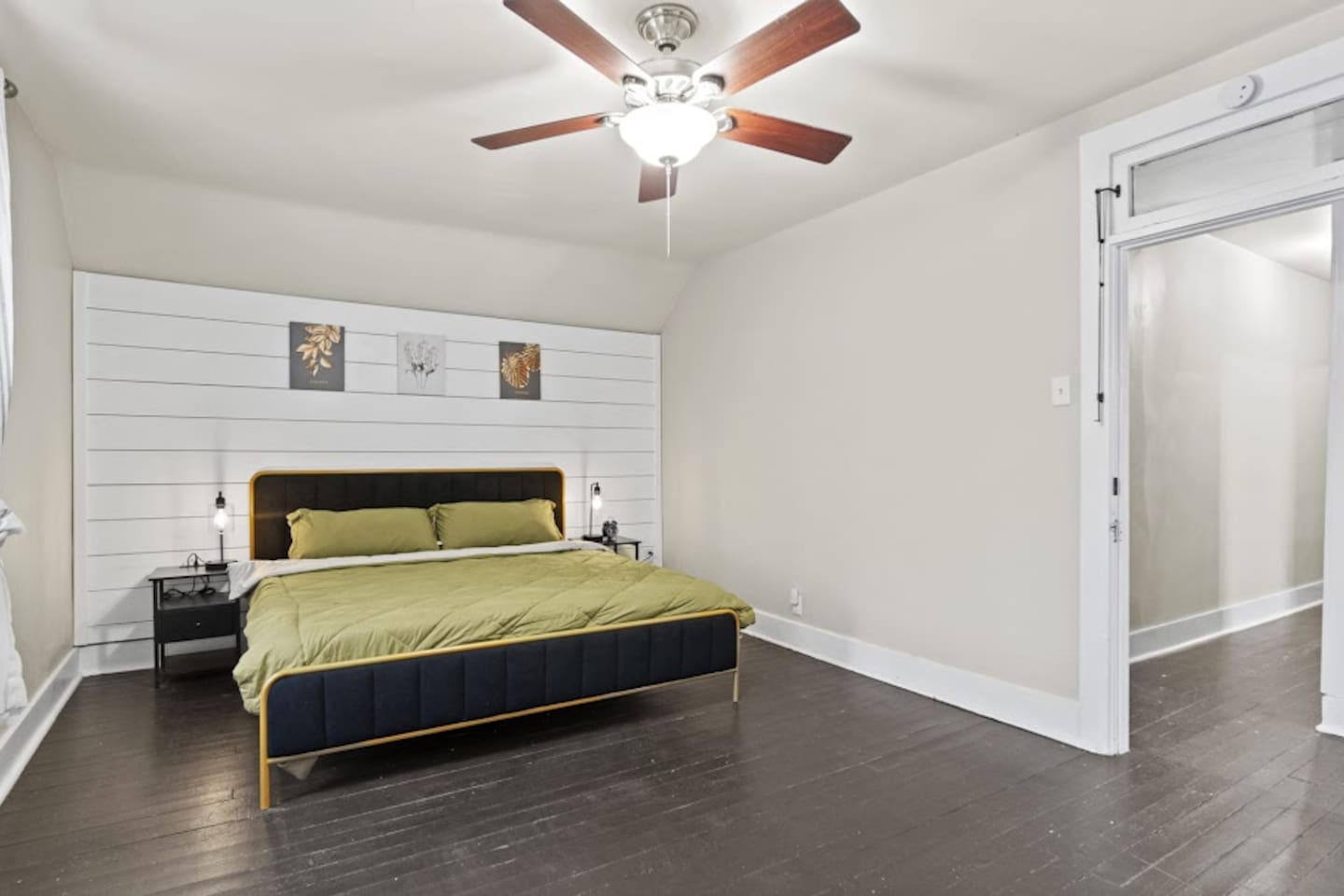 Elegant bedroom featuring a luxurious bed, pristine white walls, and a stylish chandelier fan—creating a sophisticated and tranquil atmosphere for relaxation and modern comfort in a beautifully designed space