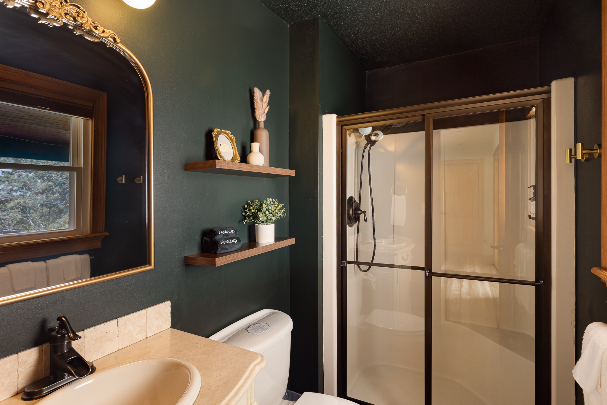 {Bathroom 4} Moody green finishes and a full shower create another thoughtfully designed bathroom for your group.