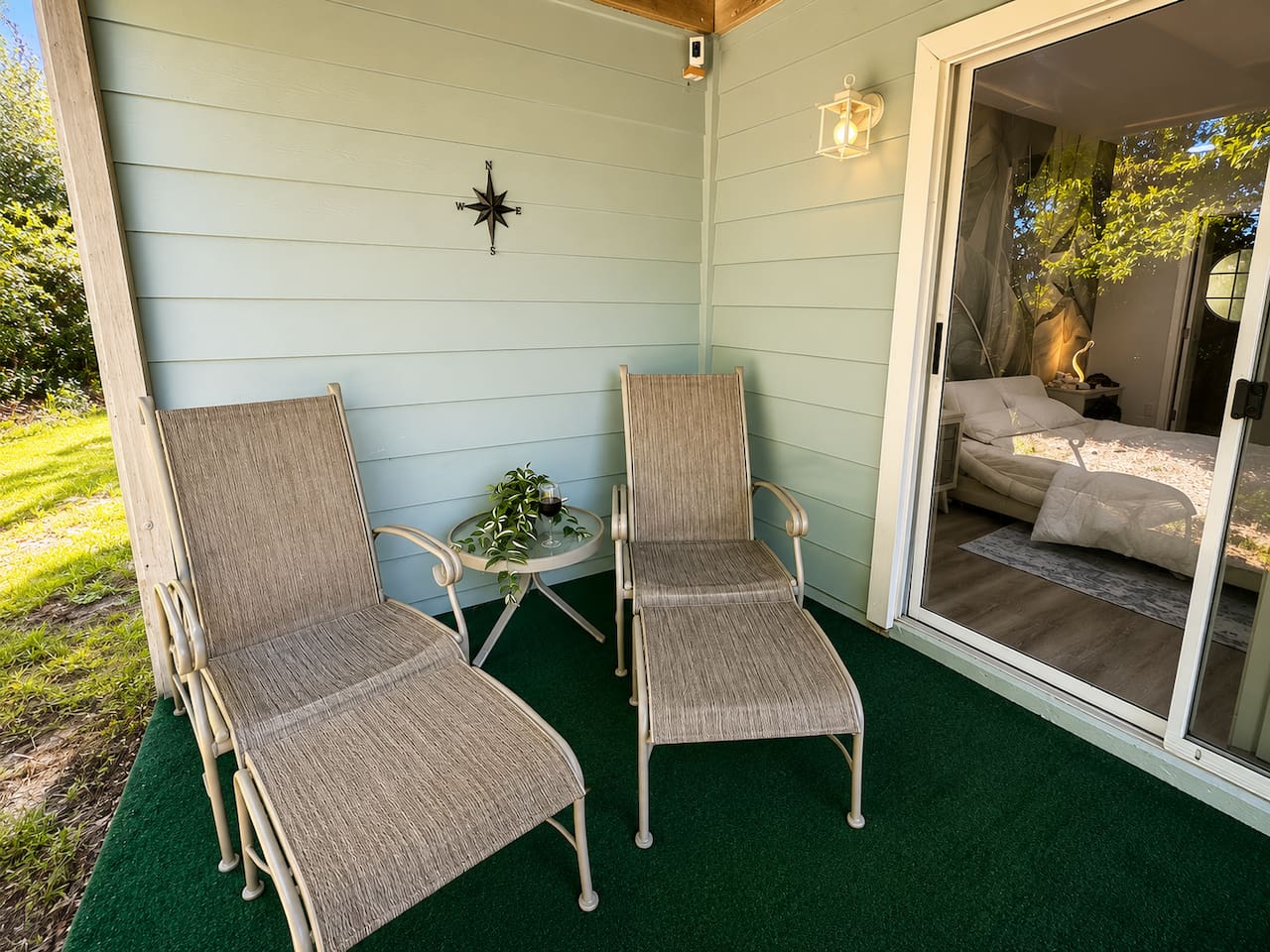 Private covered patio with comfortable seating and direct access to the bedroom.