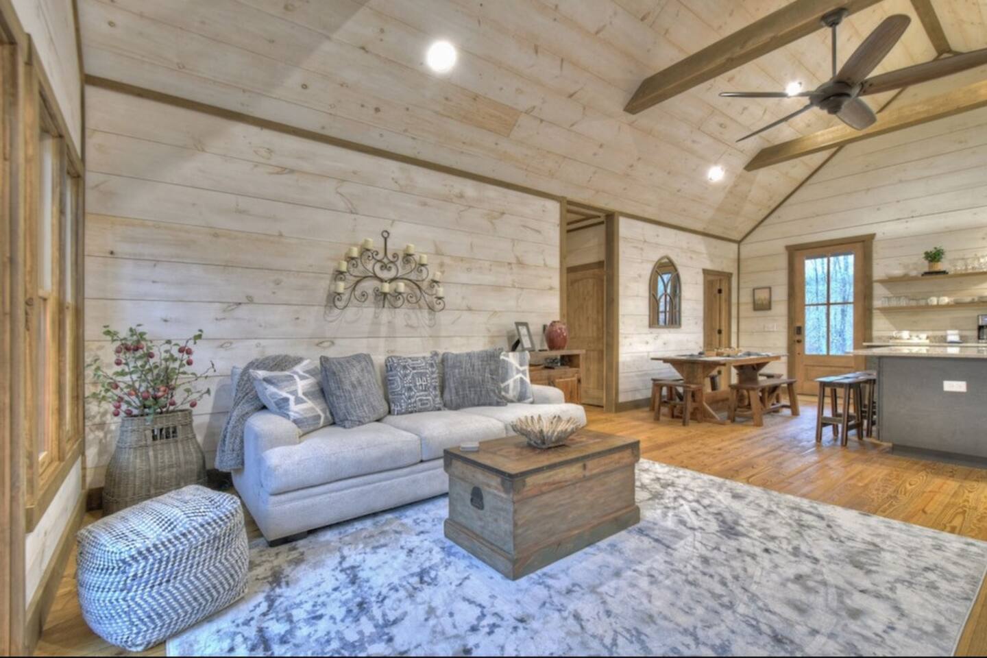 Great room connected to the kitchen on the main floorPerfect for entertaining.  High end furnishing including couch and two sitting chairs.