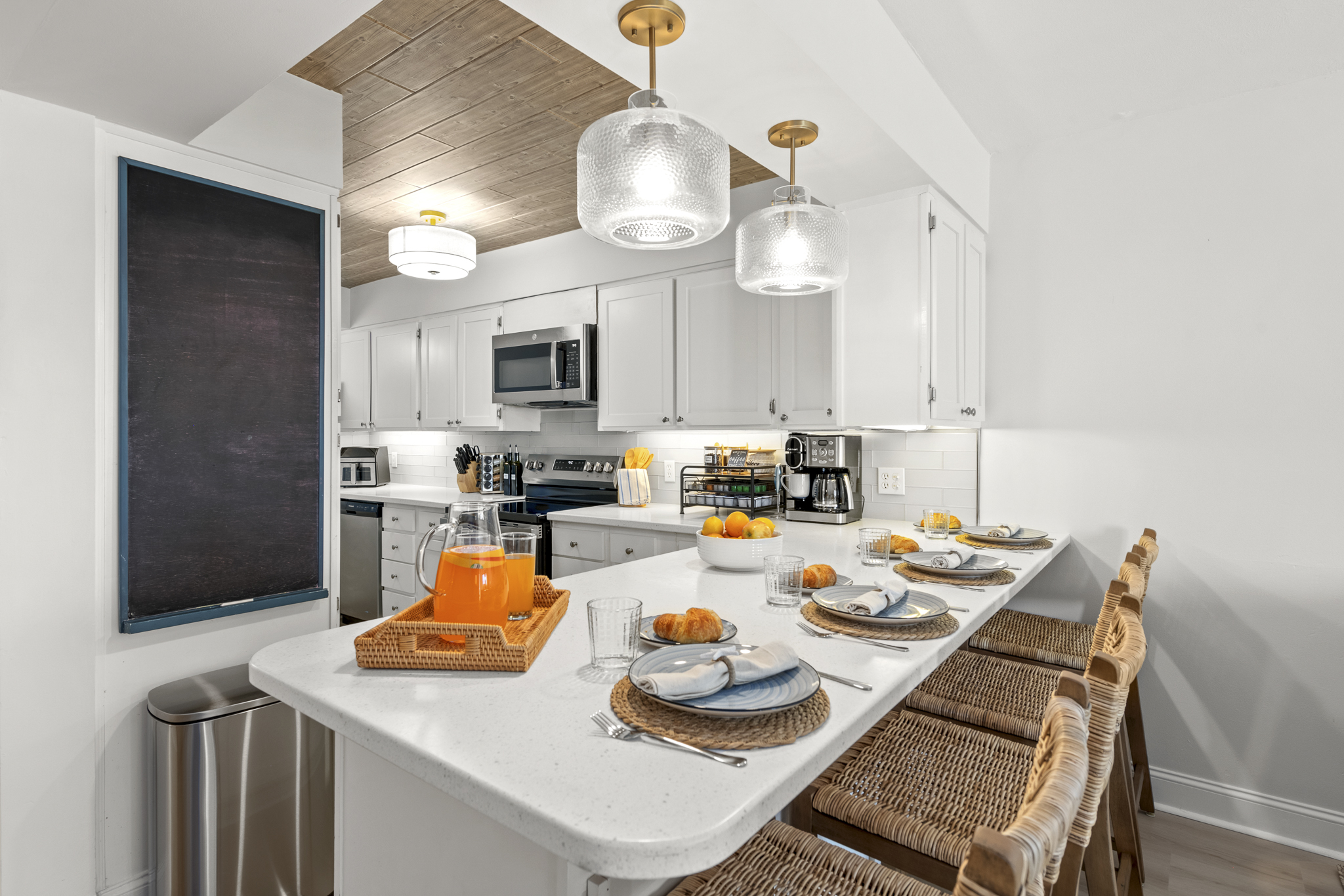 Enjoy open-concept dining with counter seating and a kitchen stocked with all the essentials for effortless meals and coastal gatherings.