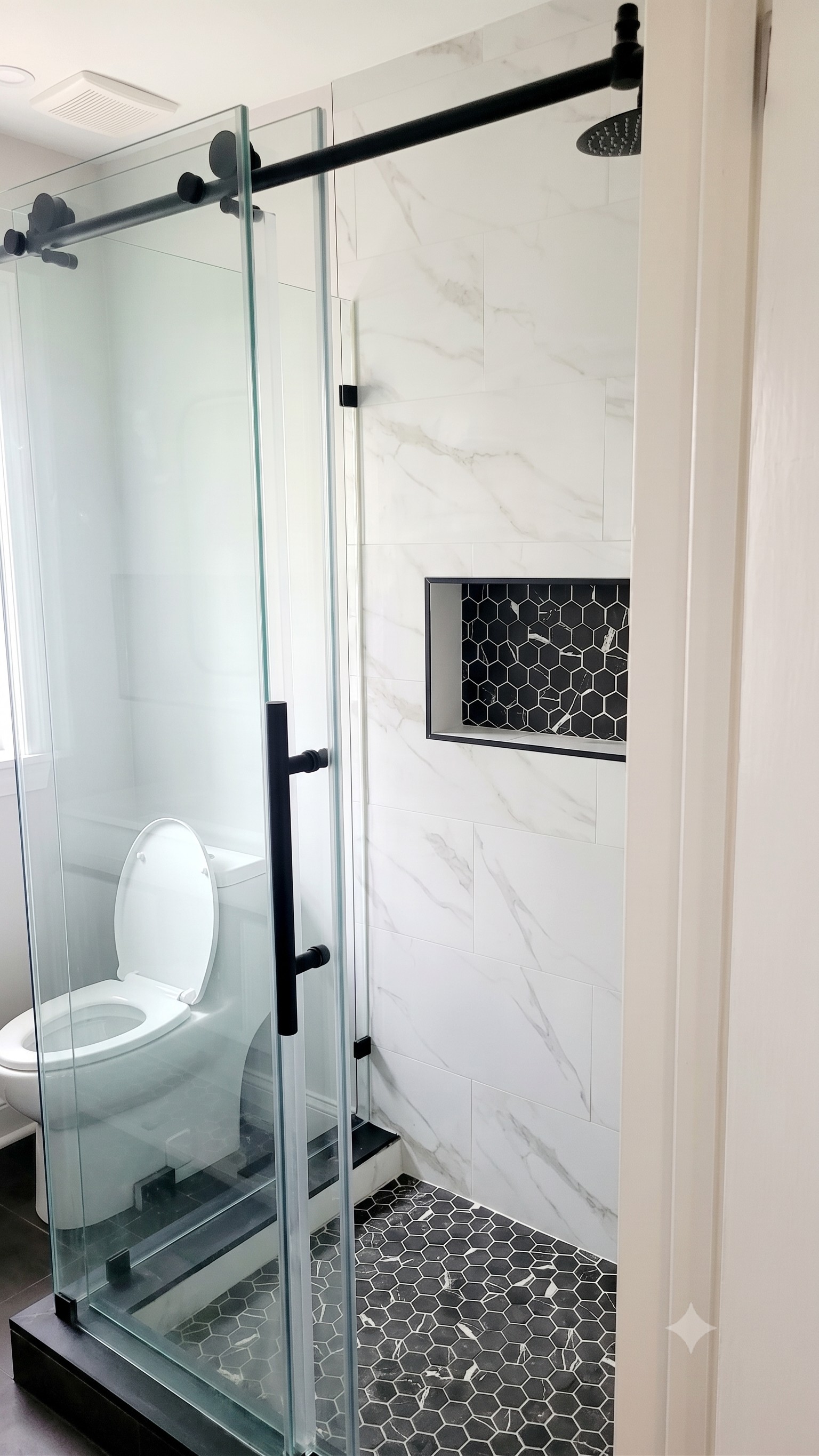 Spacious stand up shower, eco-flush toilet and state of the art vanity mirror in a spa-like bathroom