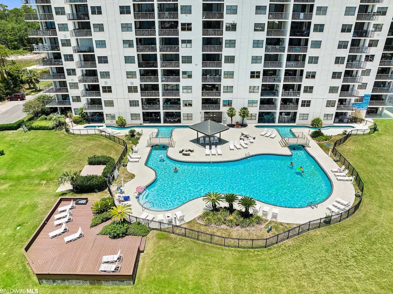 Poolside Paradise: Relax in style at our sparkling pool surrounded by lush greenery!