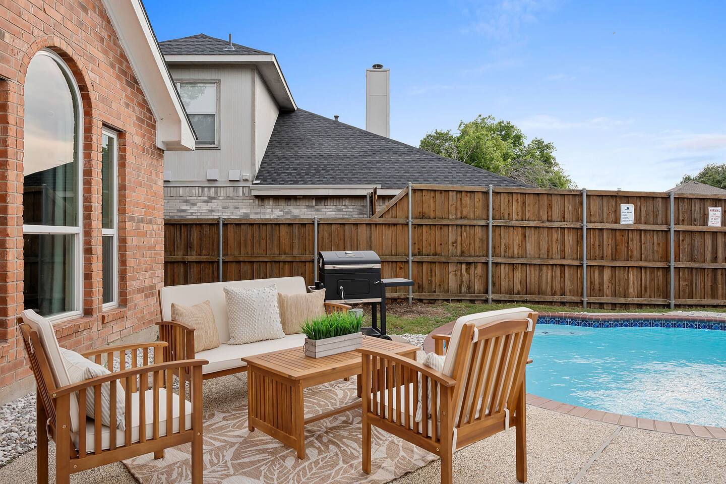 Enjoying the perfect blend of relaxation and nature in this outdoor seating area near the pool in the backyard.