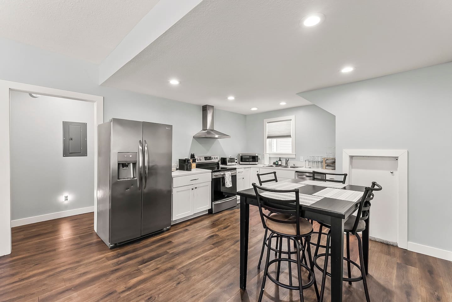 Open kitchen and dining area with modern finishes, perfect for shared meals or morning coffee in downtown Fort Wayne.
