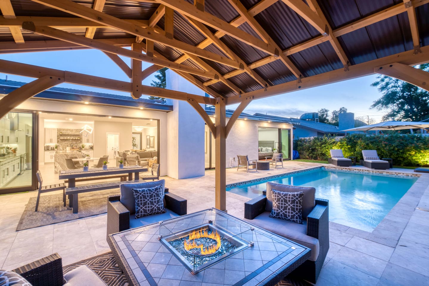From fire-lit gatherings to starlit swims, this backyard setup brings elegance and comfort to your nights.