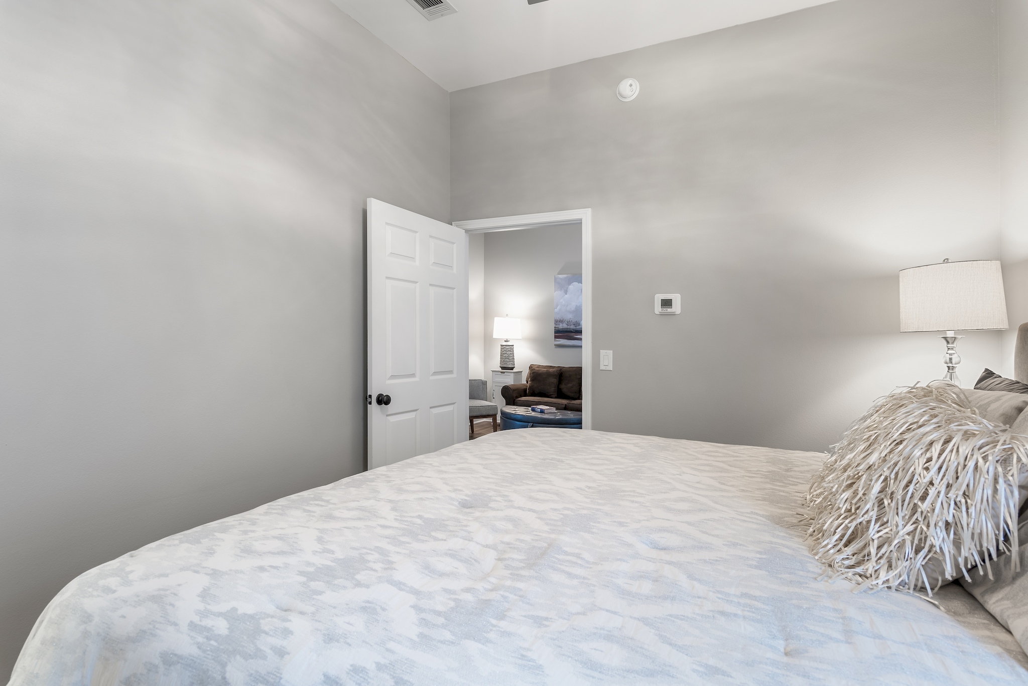  Bedroom with plush bedding and soft coastal lighting