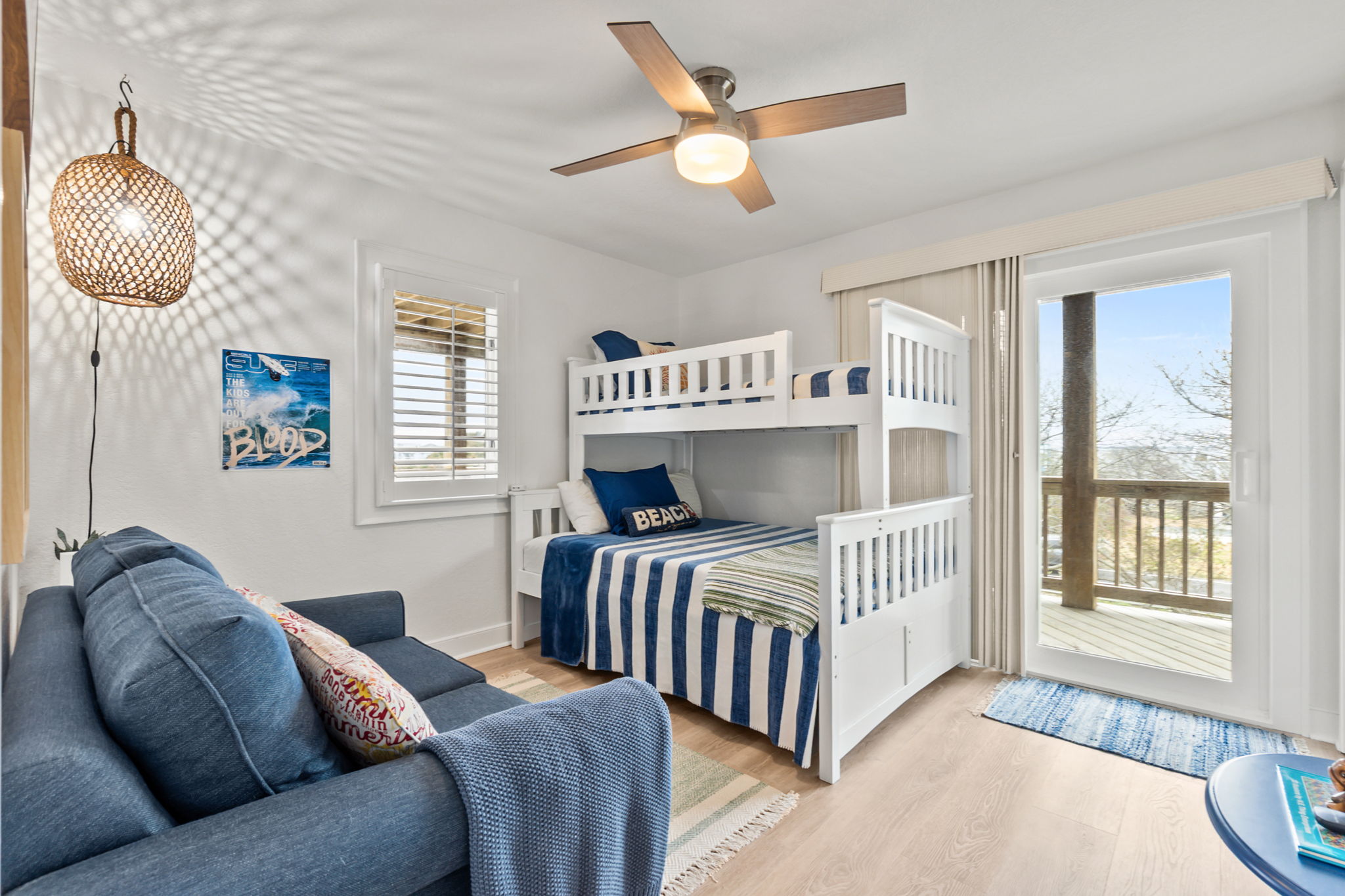 Fun bunk room with twin-over-double beds and a small seating area & deck access
