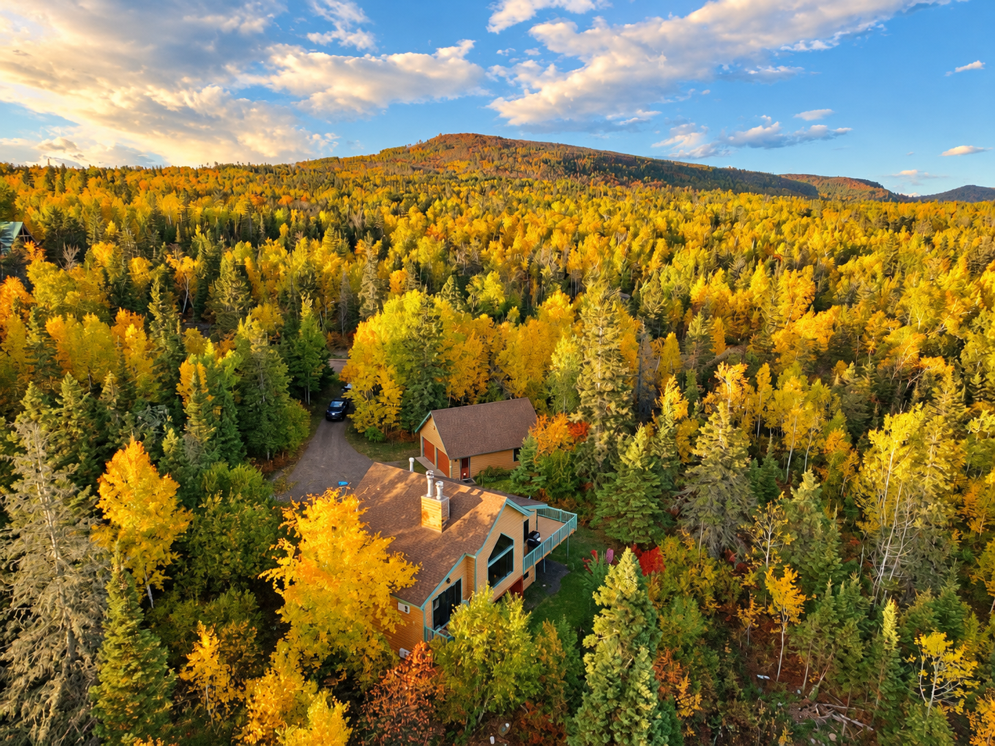 Nestled among brilliant golden aspens and vibrant autumn foliage, this secluded North Shore cabin shown with Laveaux Mountain in the background. Experience the magic of Minnesota’s fall colors, surrounded by peaceful forest!