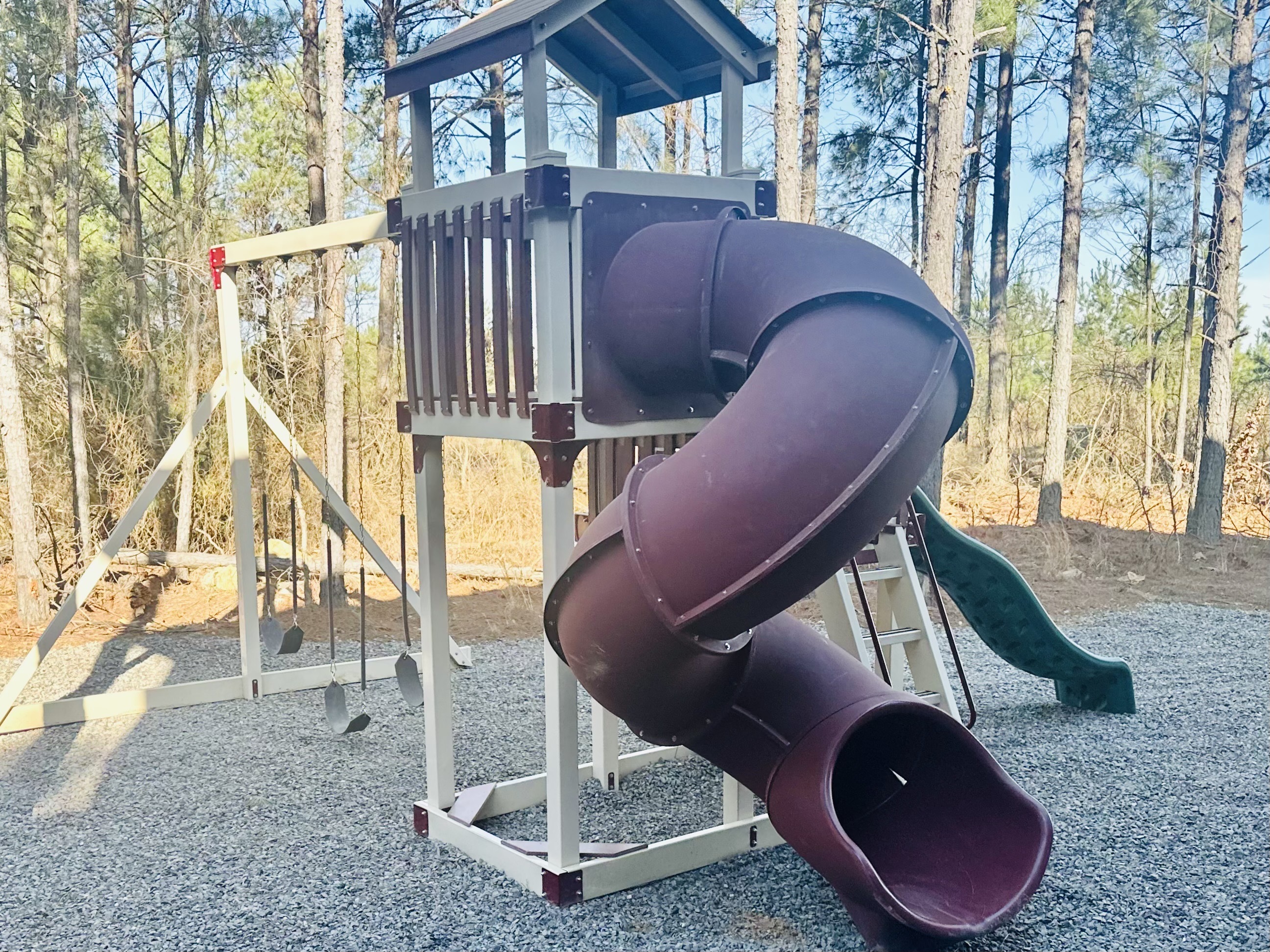 Outdoor playground set with swings and slides for kids to enjoy.