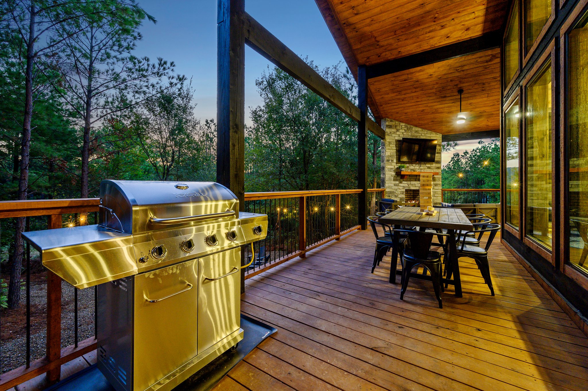 Modern cabin living: Huge covered deck, fireplace, and grill.