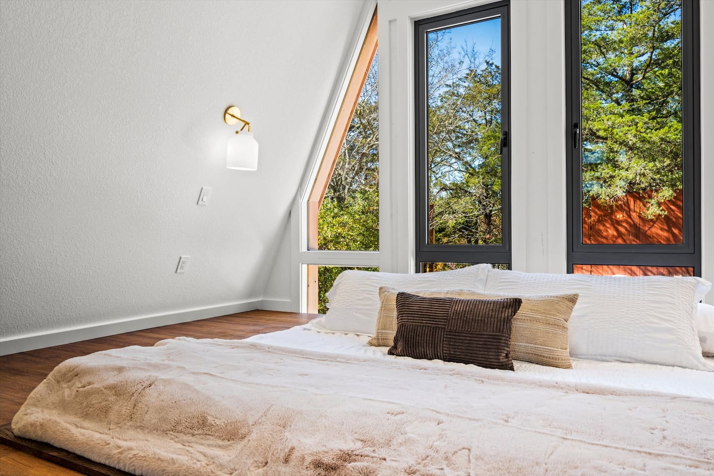 Cozy up under crisp sheets in this calm and modern bedroom.