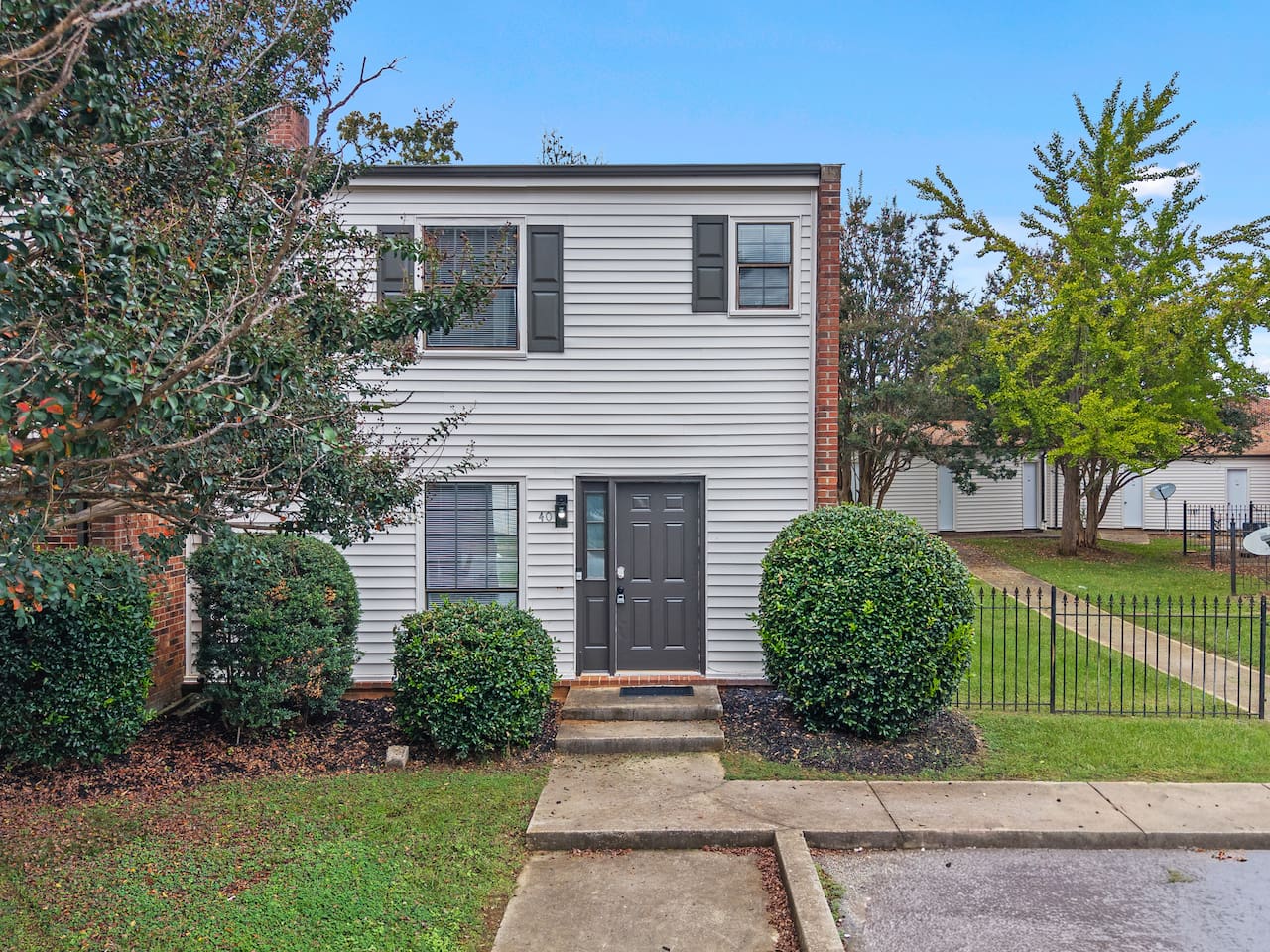 Welcoming front entrance with classic brick accents and well-kept landscaping.