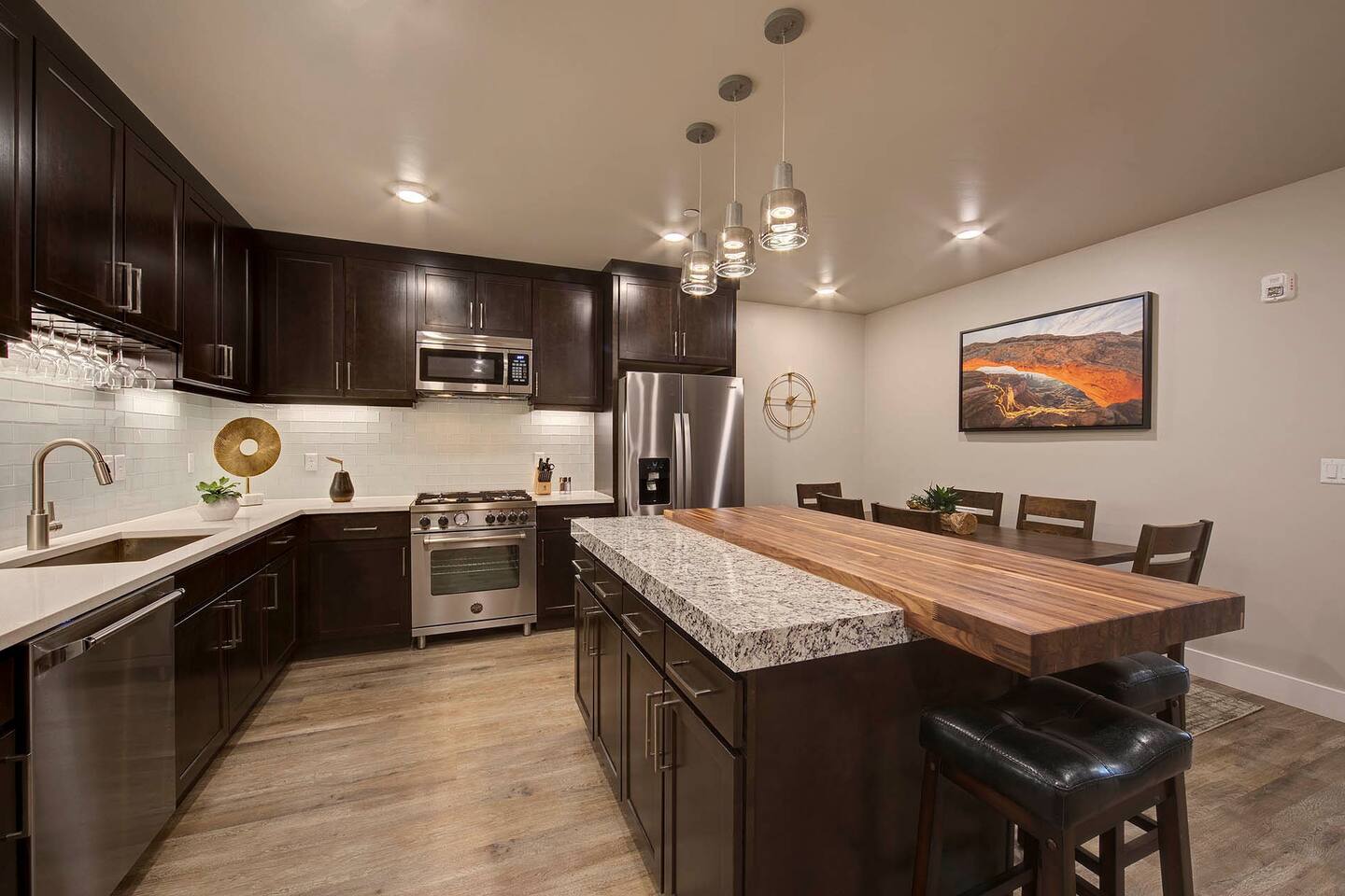 The modern kitchen features an island and extra seating for four.