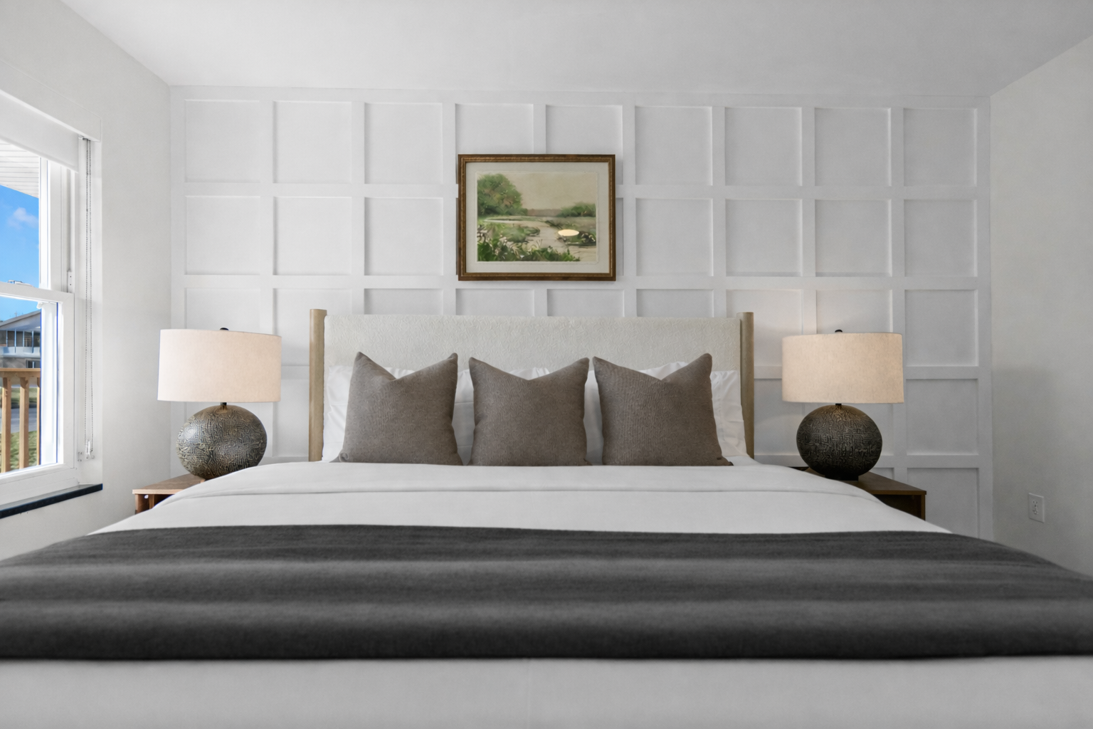 Serene bedroom featuring a plush bed, elegant accent wall, and warm lighting—creating a calm, comfortable retreat for restful nights.