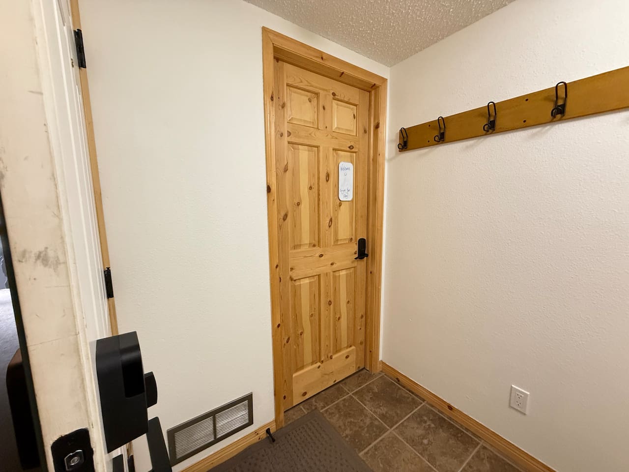 Shared entry leading to your private bed and bath, secured with a smart lock and your own code. A solid pine door and cozy mountain touches ensure comfort and privacy throughout your stay.