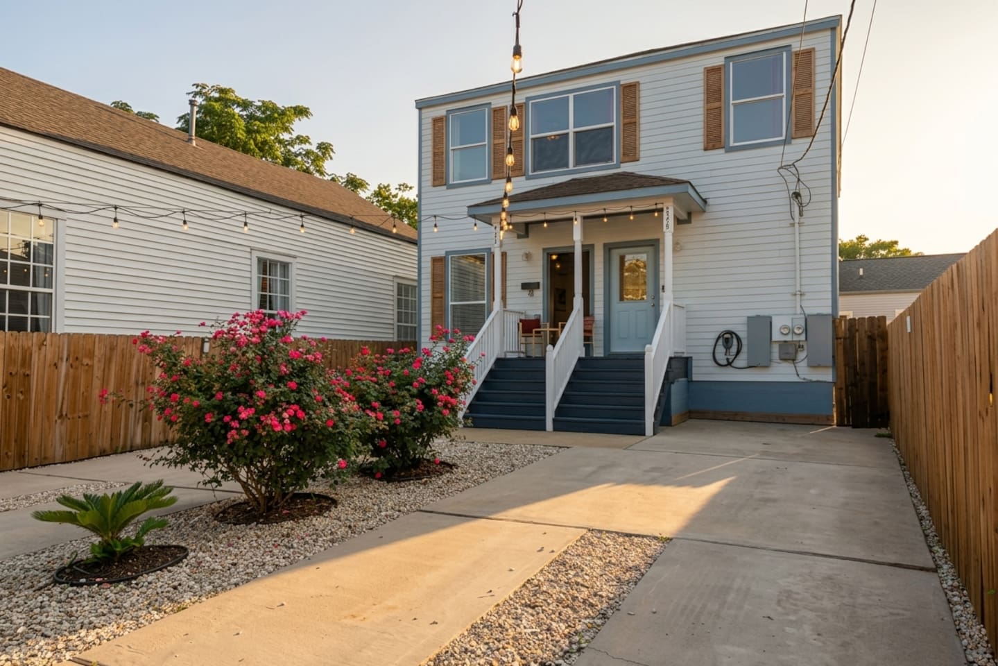 String lights, Electric Vehicle Charger, rose bushes, seating, and plenty of private fenced parking in front of the house!