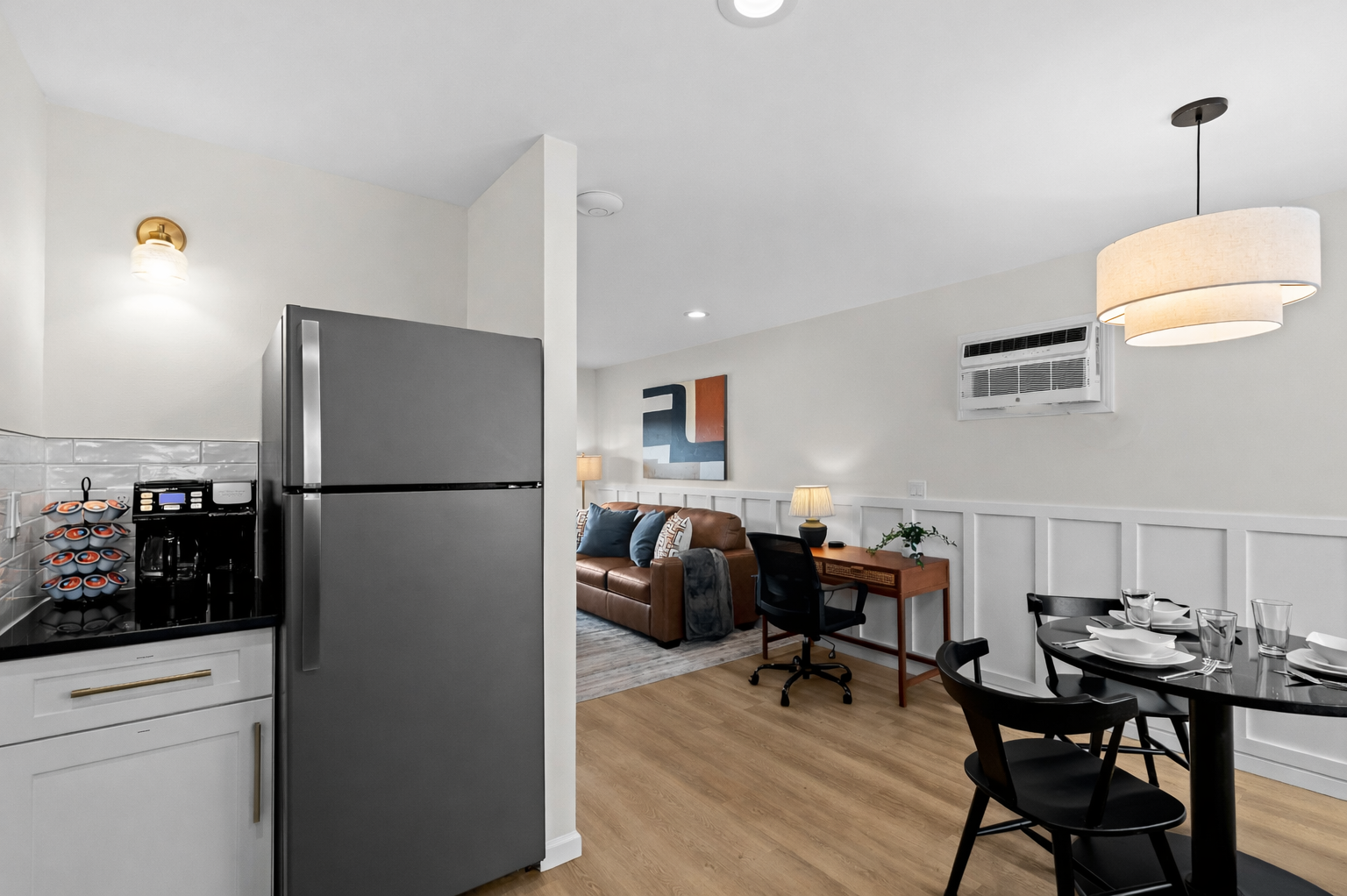 Open-concept layout with modern kitchen, dining area, and dedicated workspace—perfect for working, dining, and relaxing in comfort.
