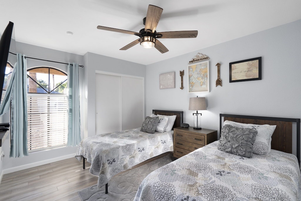 Twin bedroom-2 beds, TV, closet, nightstand, alarm clock.