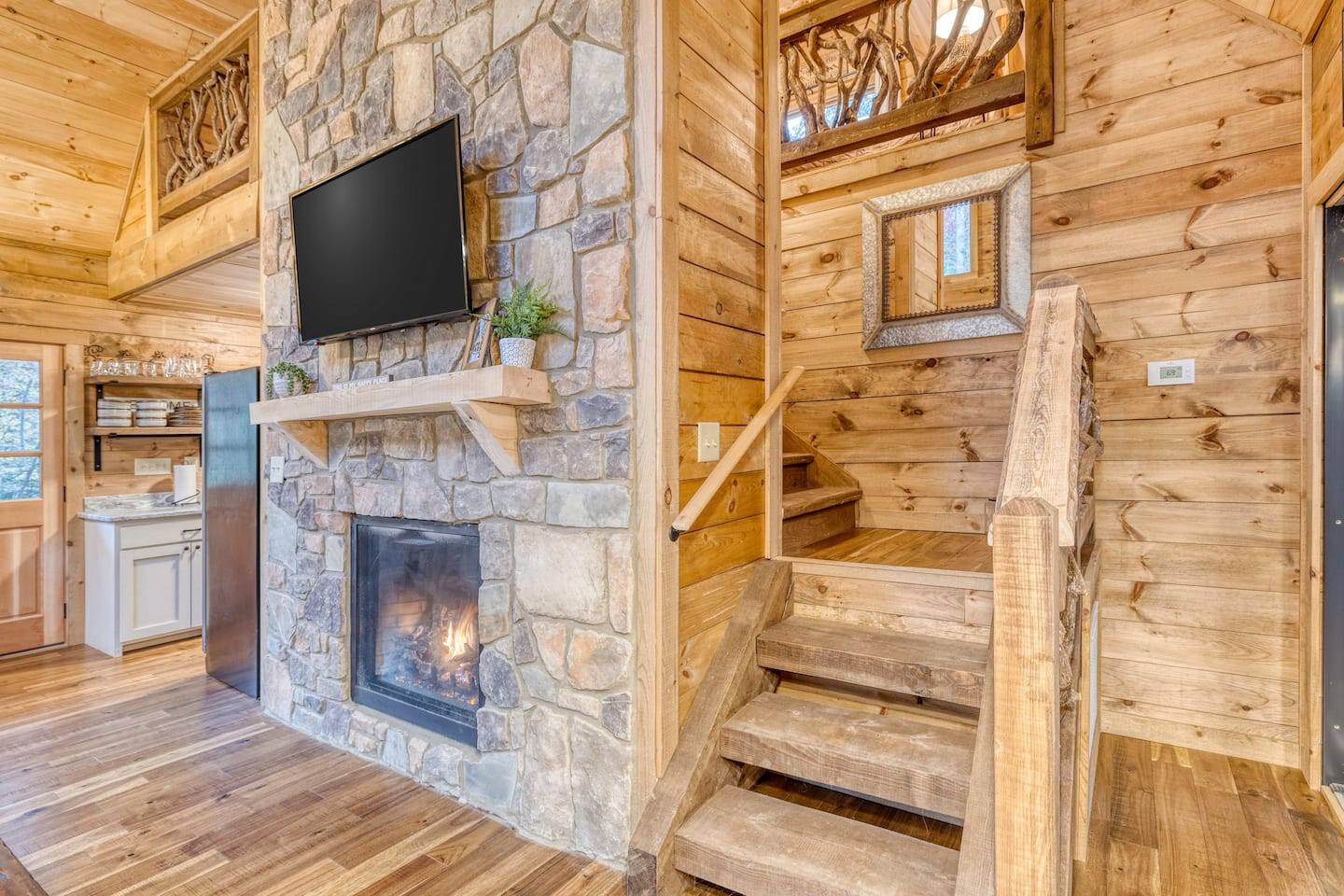  Beneath the glow of the flat screen TV, our fireplace radiates warmth and comfort, creating a harmonious fusion of entertainment and relaxation in the heart of our home