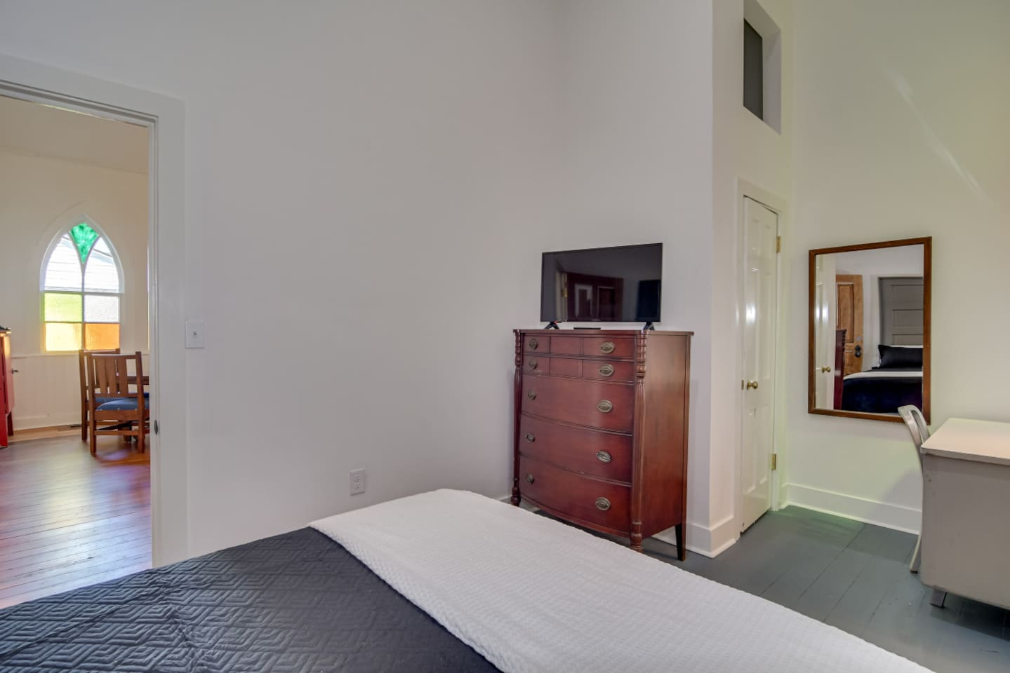 Guest bedroom with cozy queen bed and a TV