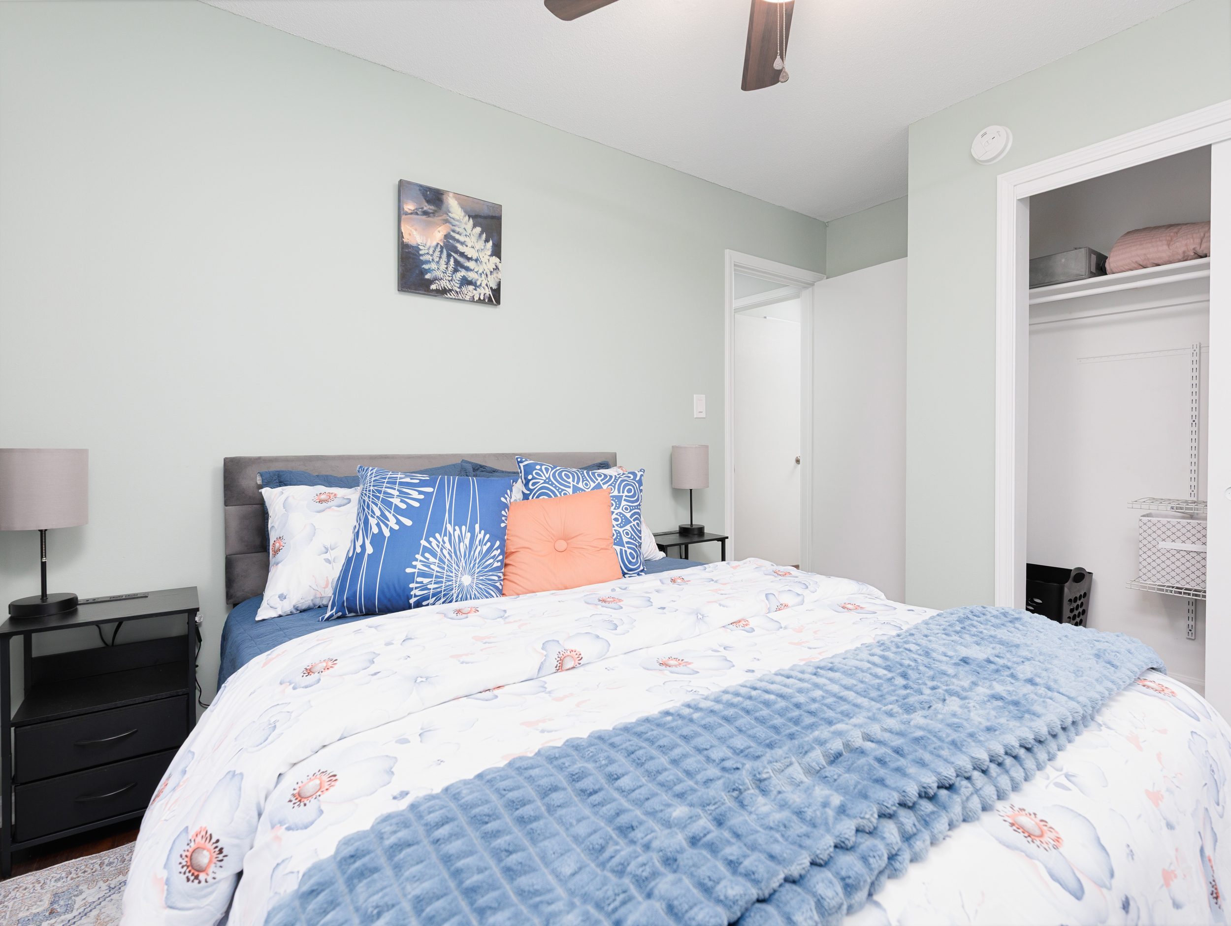 Comfortable guest bedroom with queen bed, soft natural light, and neutral décor.