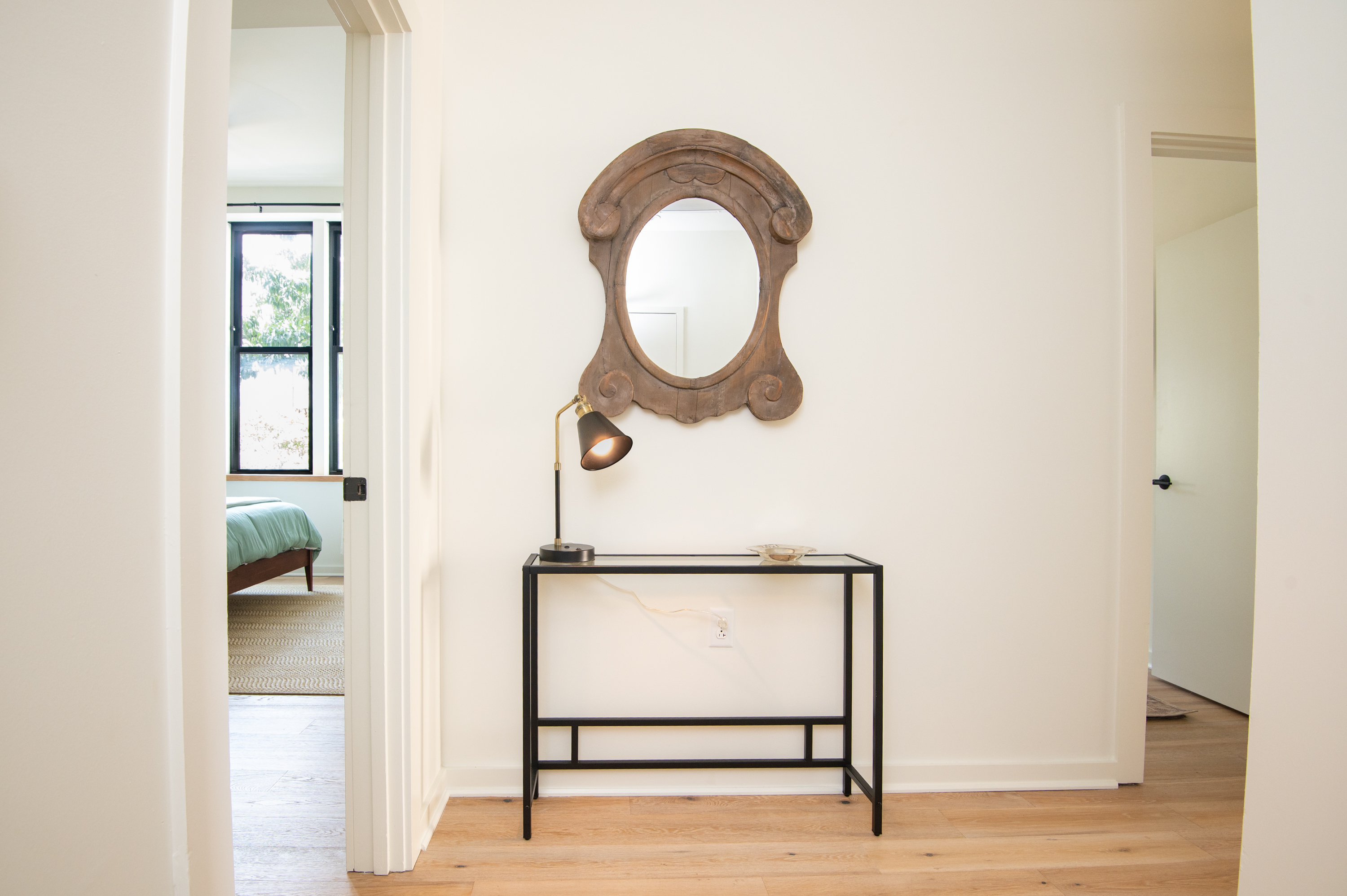 Hallway view with decorative mirror and console table accent