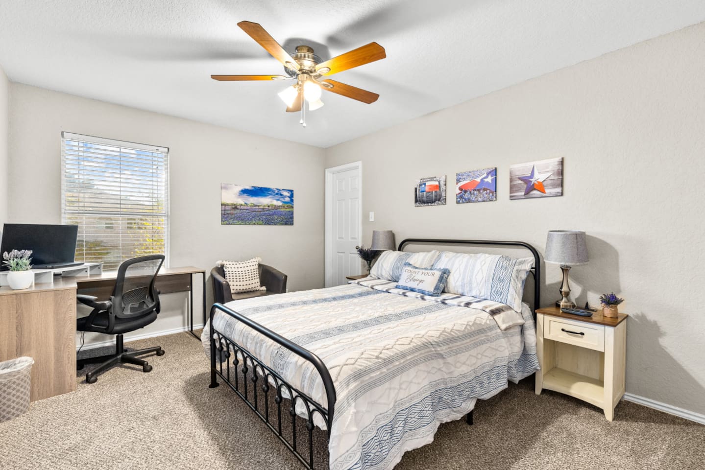 Queen bedroom retreat featuring a dedicated workspace with natural light and strong internet, plus room-darkening blinds, soft bedding, and ample closet storage for long or short stays.
