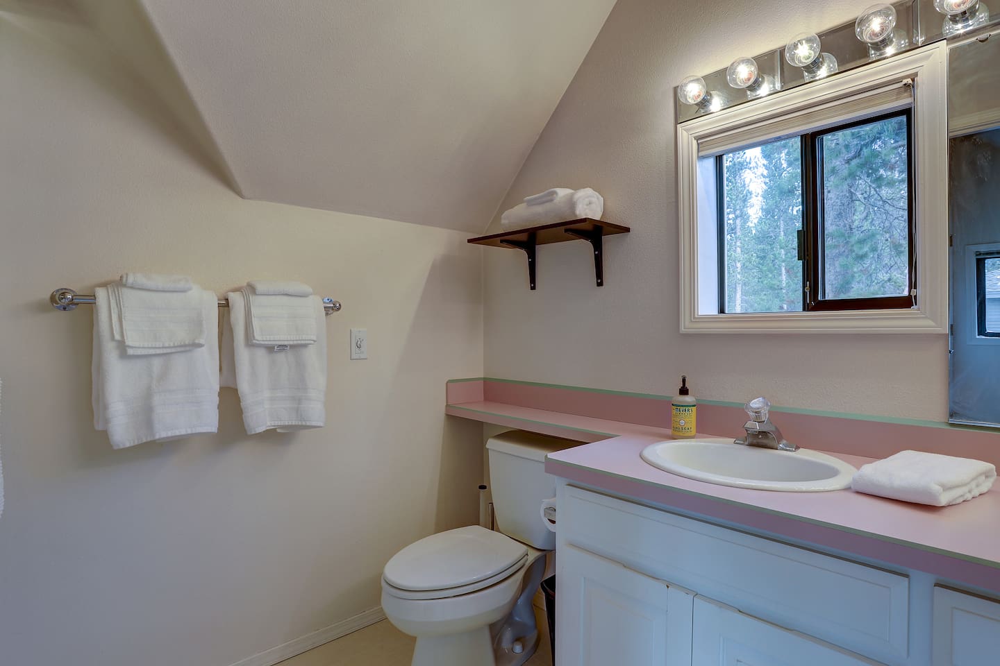 This full primary bathroom is connected to the primary bedroom and features a large shower. 