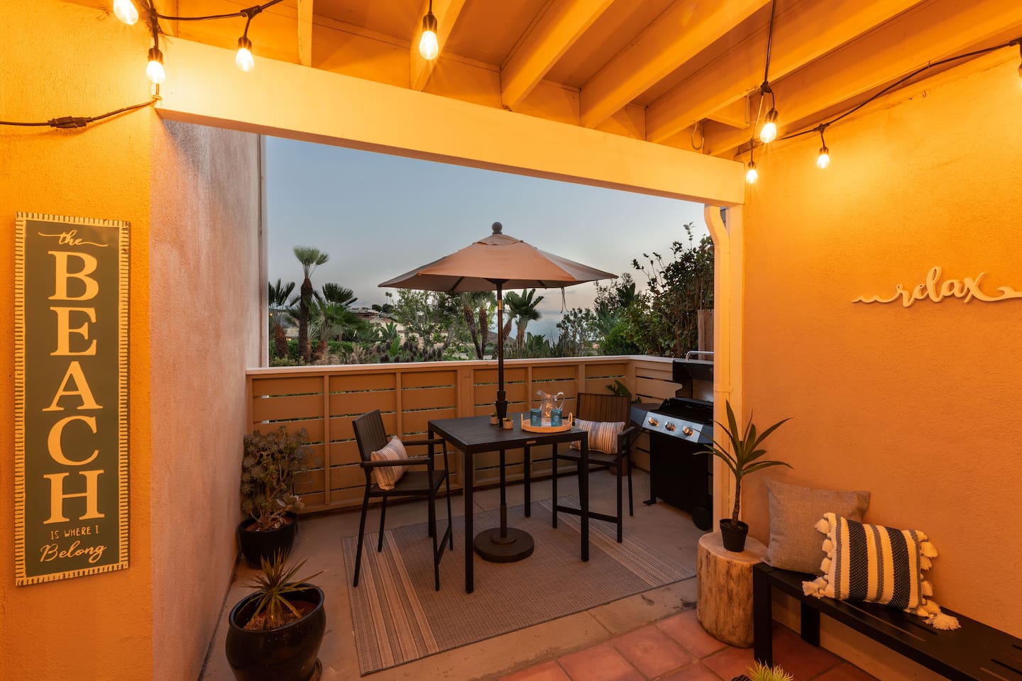 Sunset skies are visible from this patio along with some views of ocean